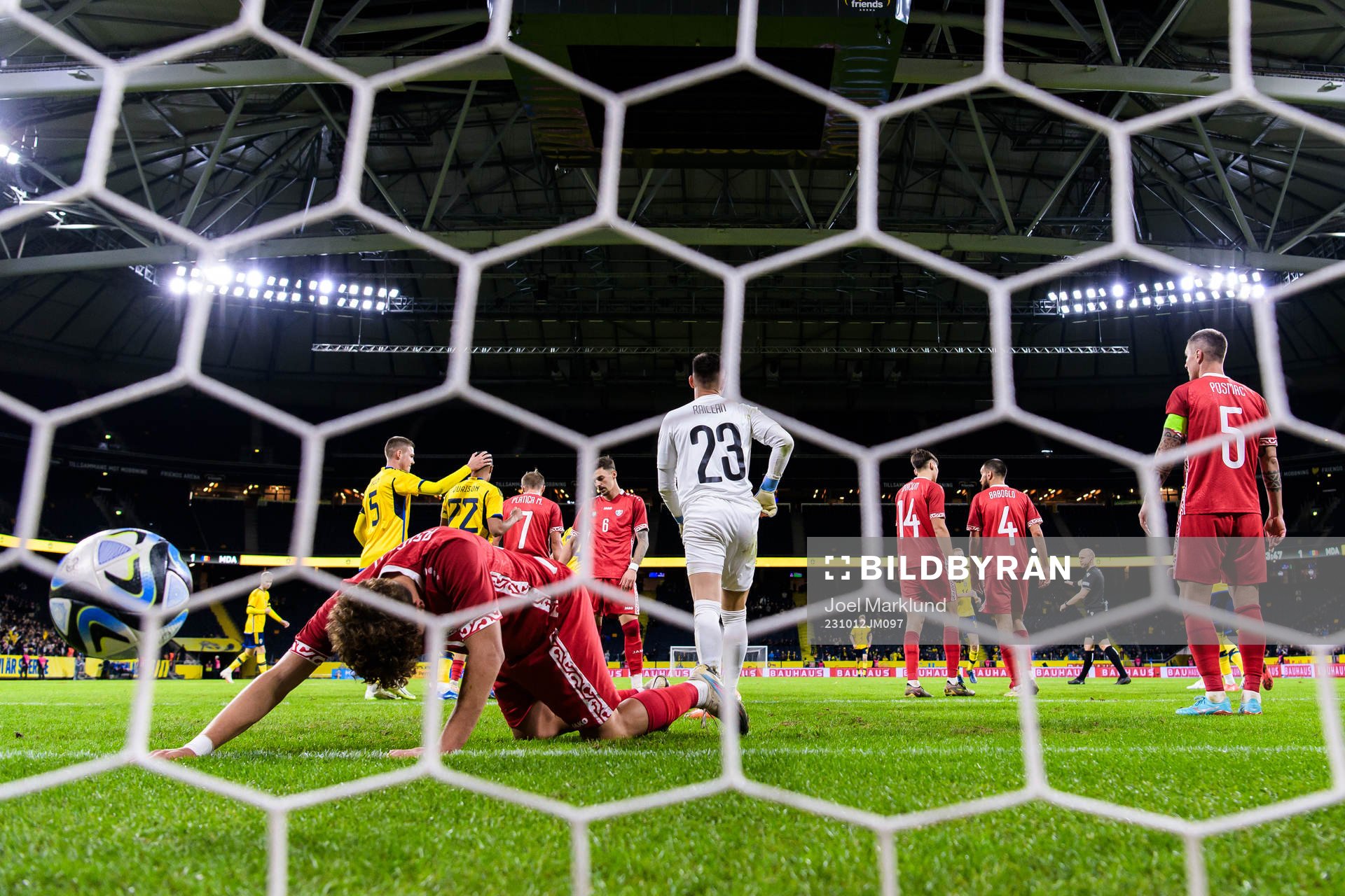Ioan-Calin Revenco and goalkeeper Dorian Railean of Moldova