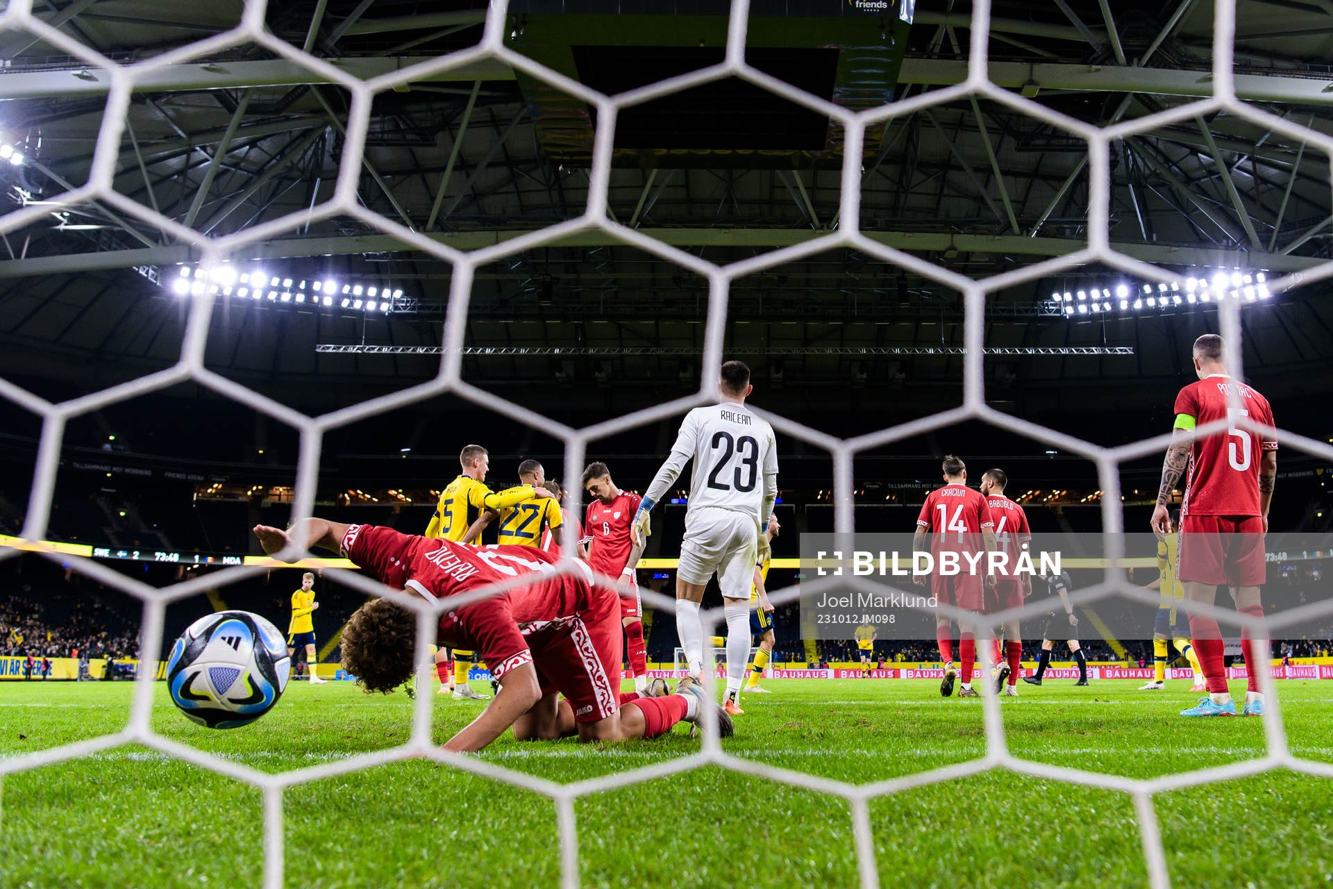 Ioan-Calin Revenco and goalkeeper Dorian Railean of Moldova