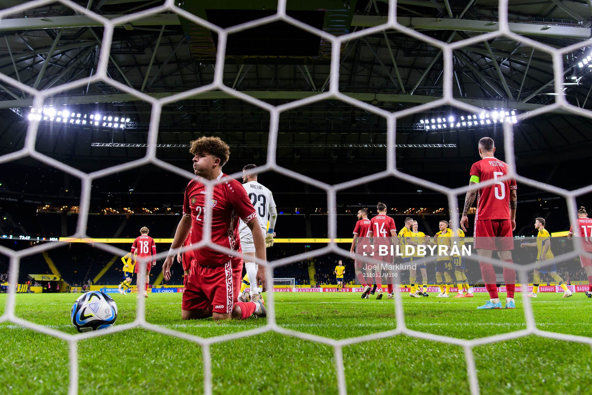 Ioan-Calin Revenco and goalkeeper Dorian Railean of Moldova
