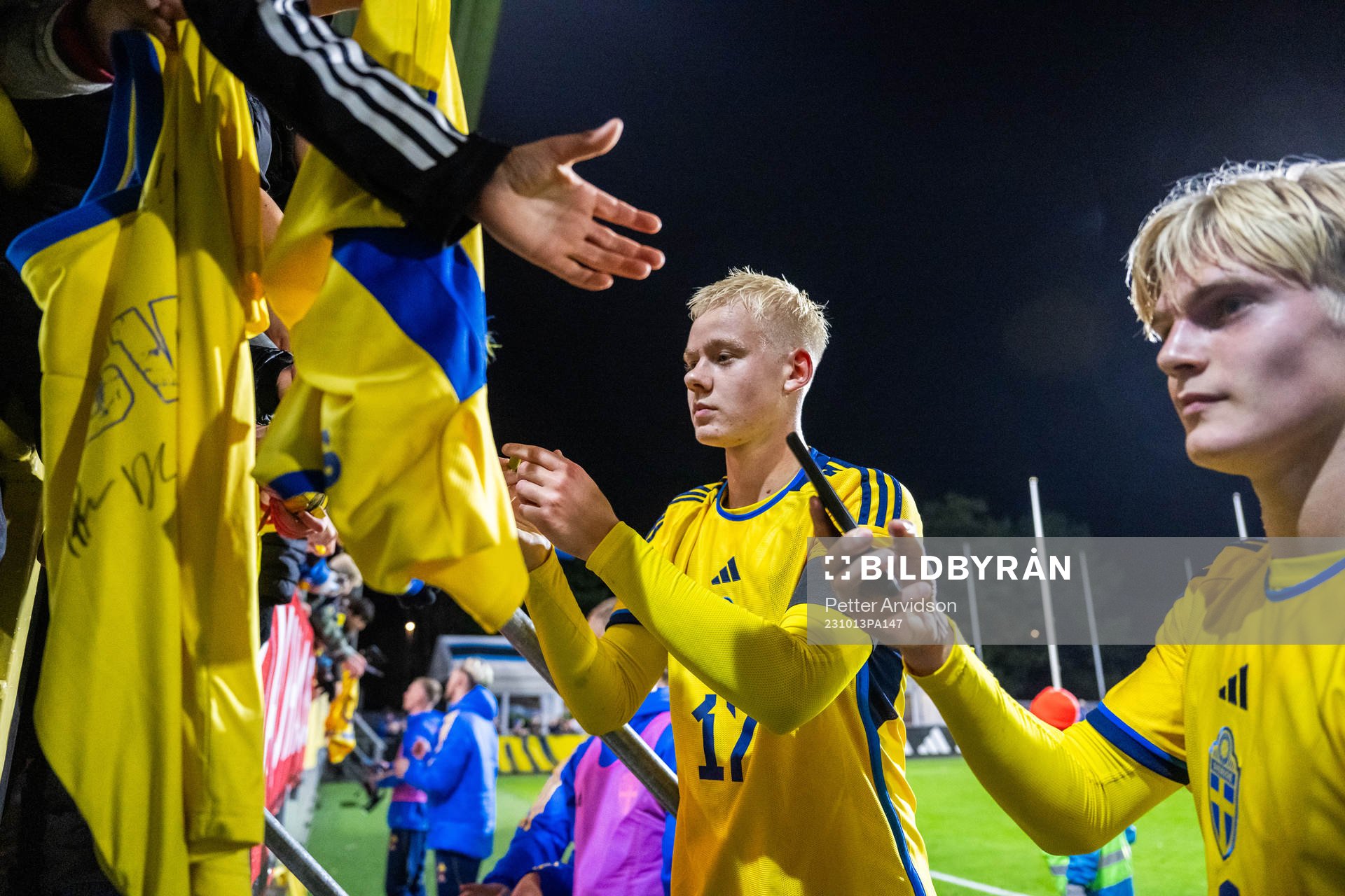 Otto Rosengren and Lucas Bergvall of Sweden write autographs