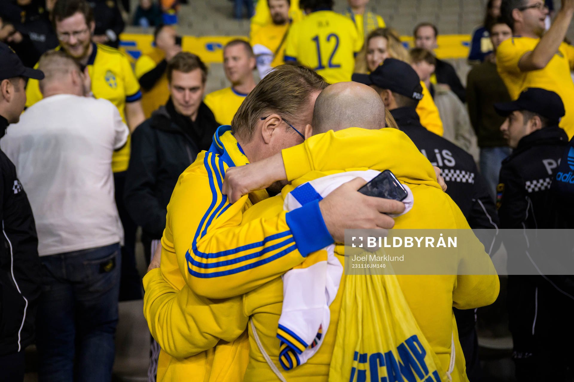 Swedish supporters Claes Durgé and David Forsberg hug
