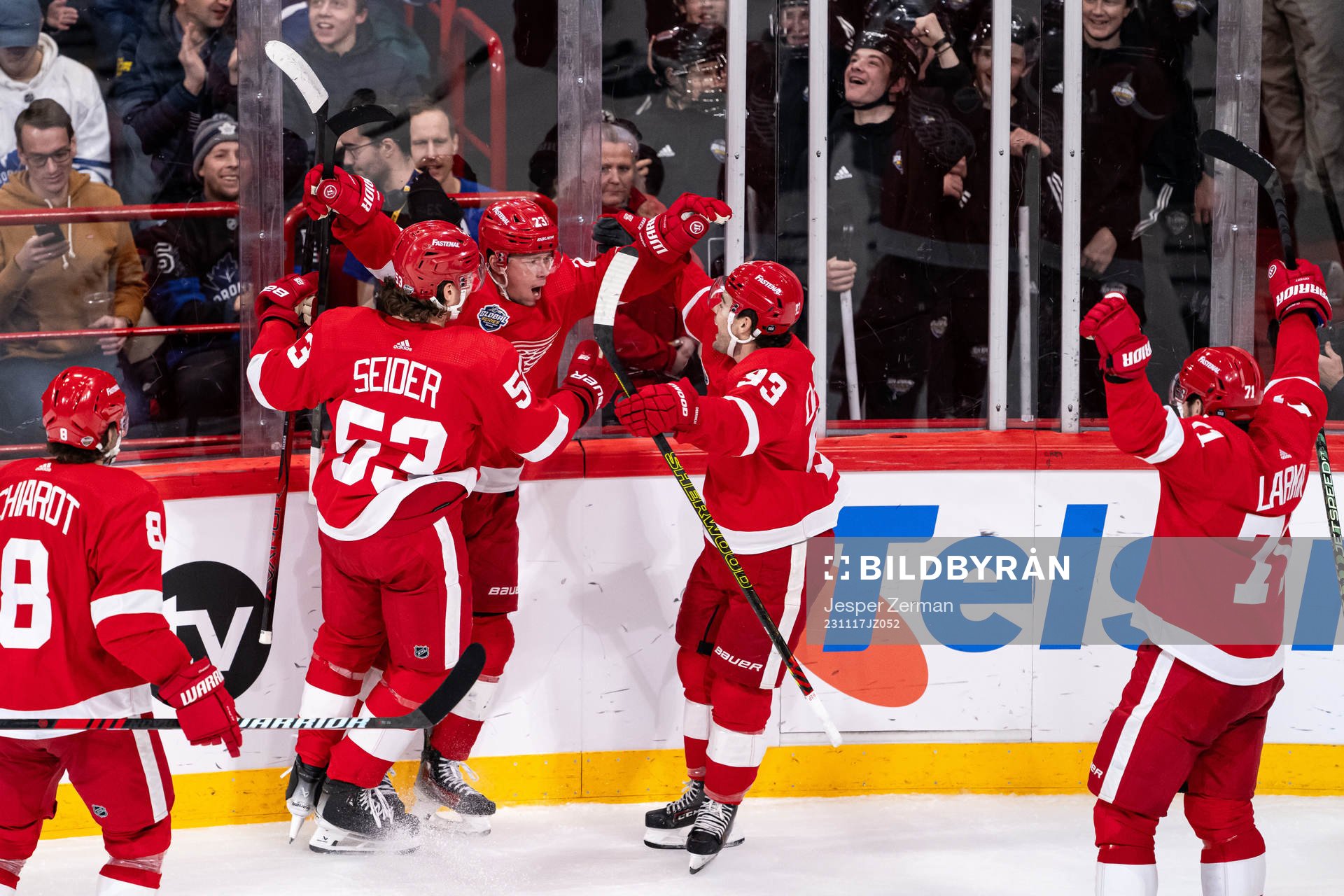 Lucas Raymond of Detroit Red Wings celebrate with teammates