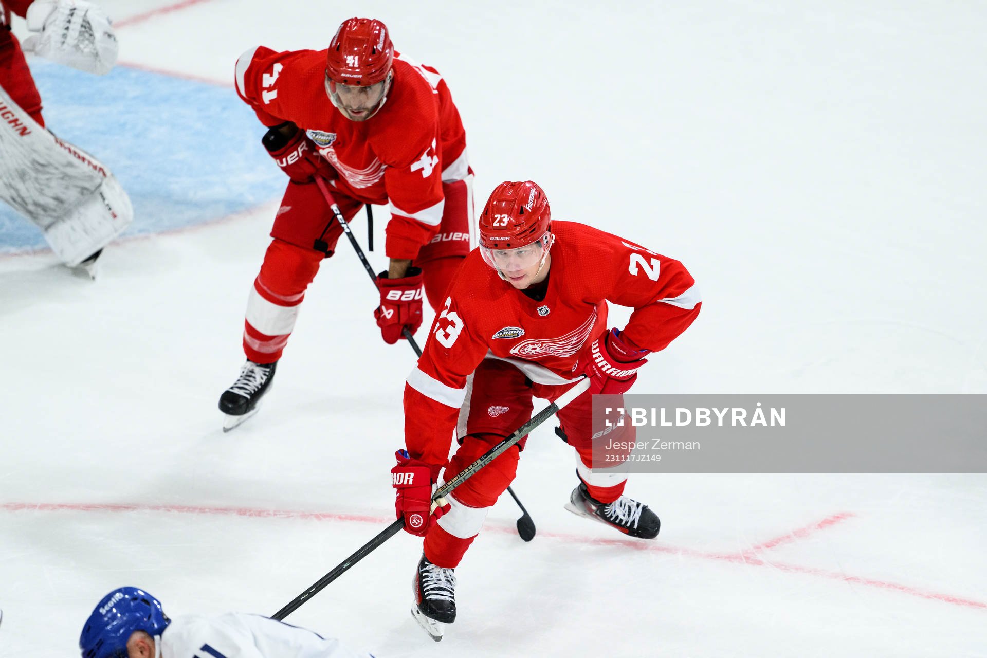 Shayne Gostisbehere and Lucas Raymond of Detroit Red Wings