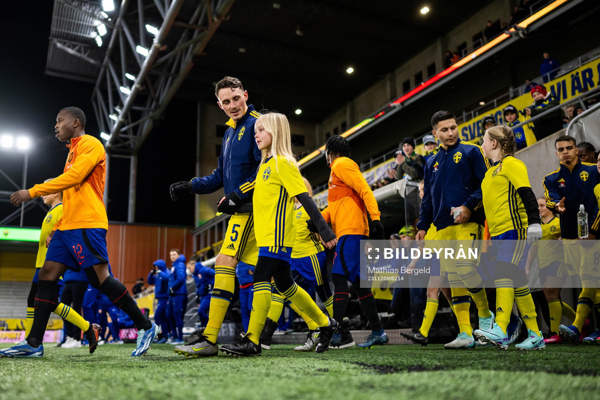 Noah Persson and Roony Bardghji of Sweden enter the pitch