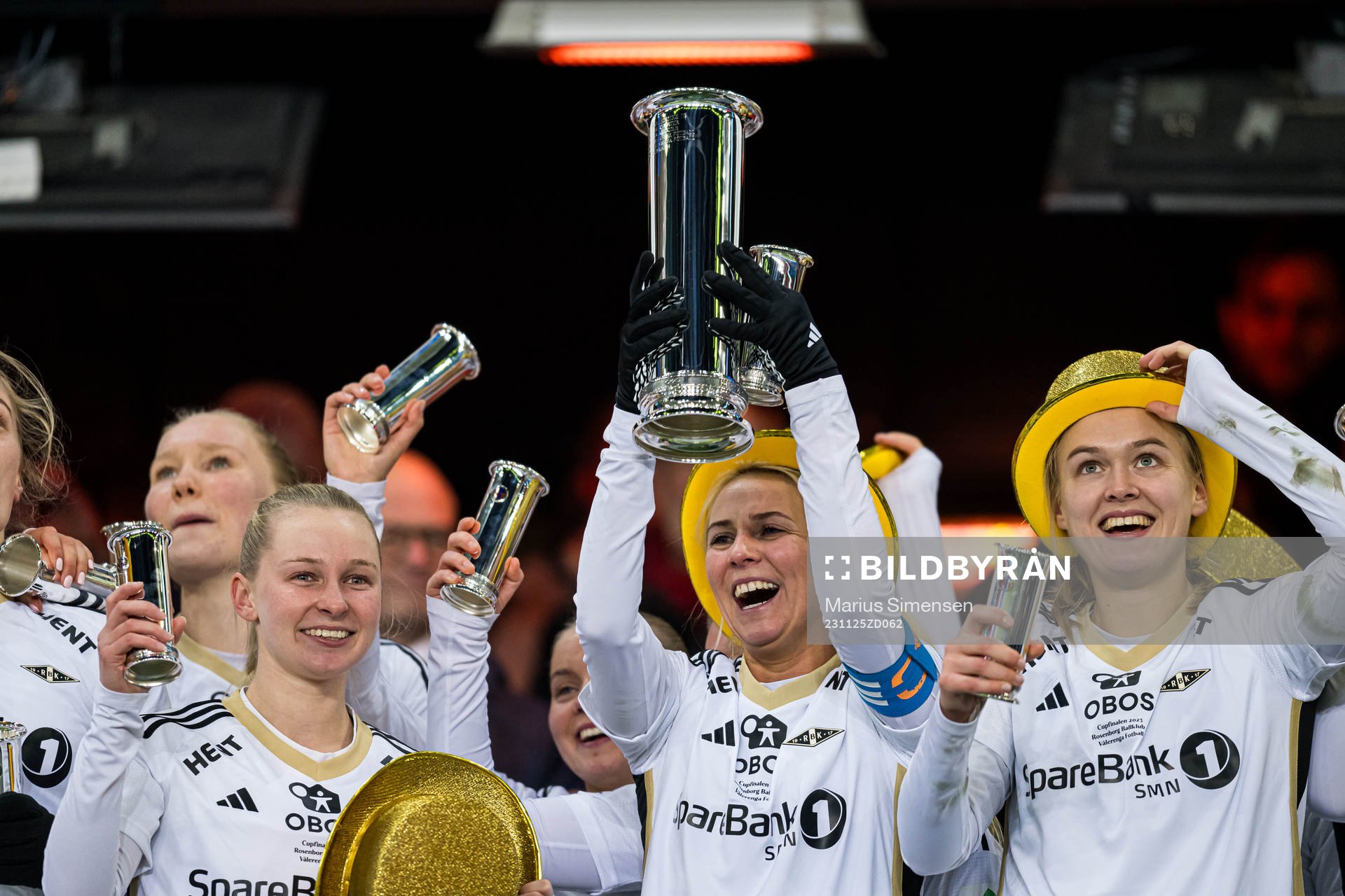 Emilie Marie Joramo, Mali Lilleås Næss and Elin Åhgren Sørum of Rosenborg celebrates with the trophy after the cup final between Rosenborg and Vålerenga on November 25, 2023 in Oslo.