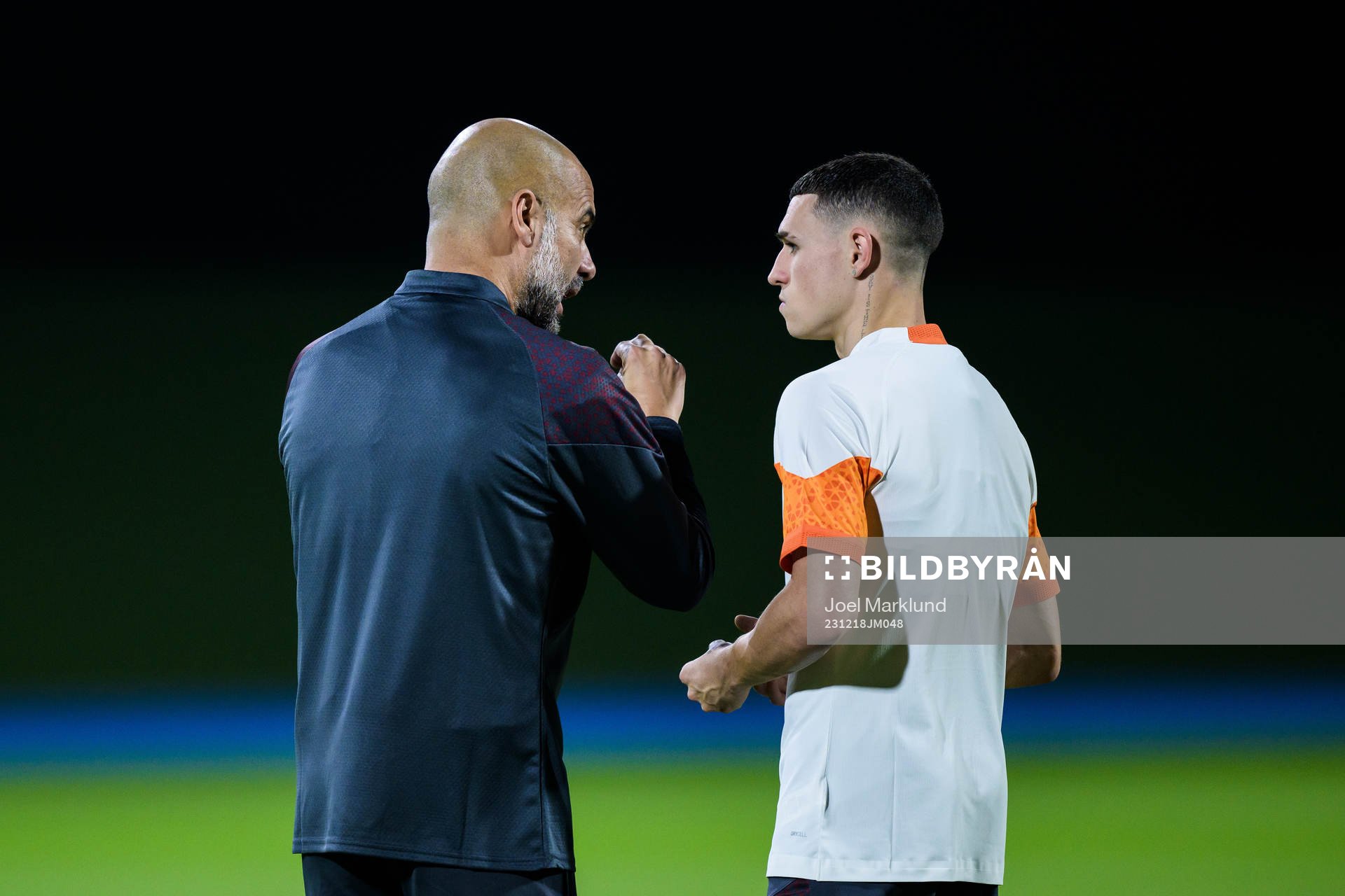 Head coach Pep Guardiola and Phil Foden of Manchester City
