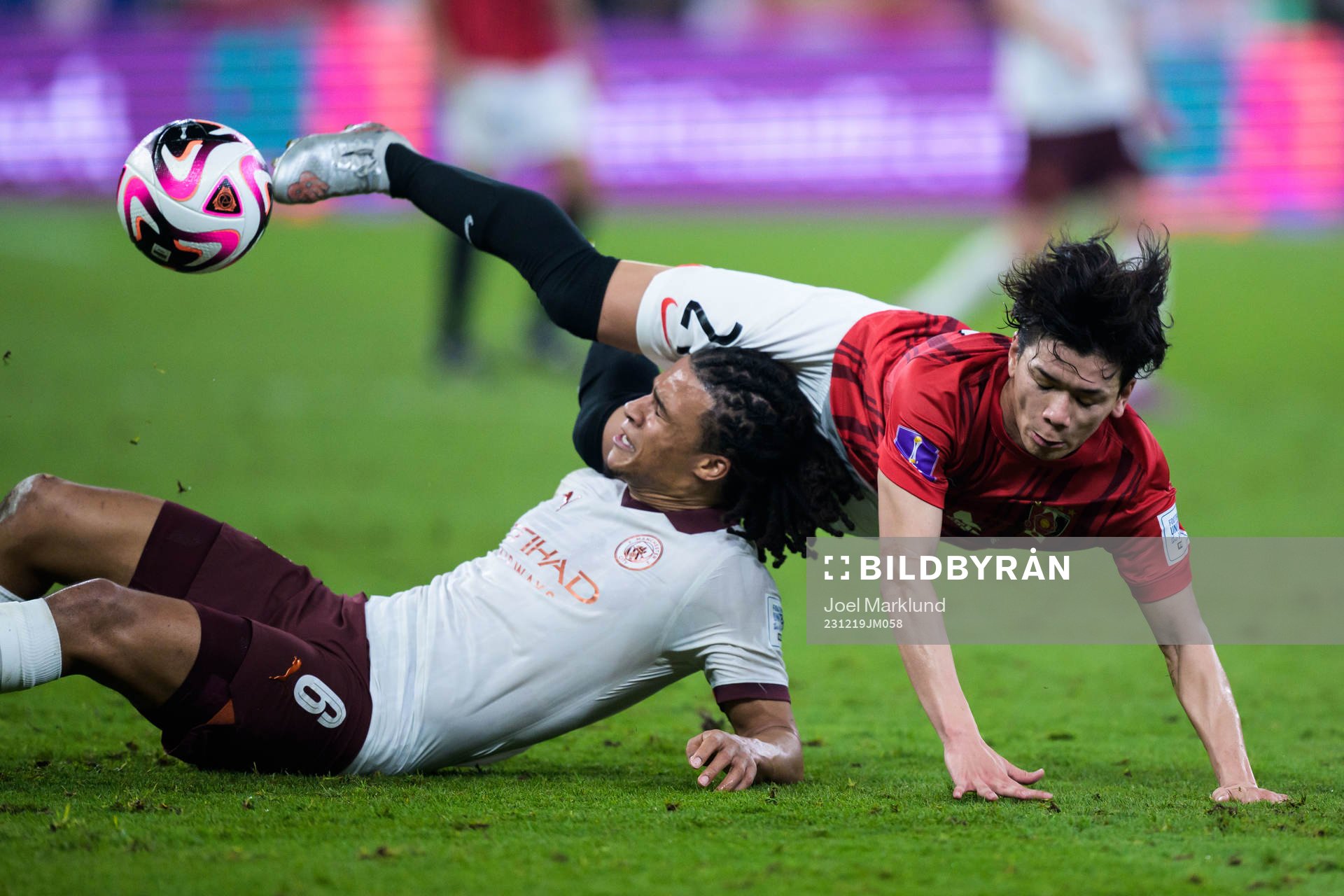 Nathan Ake of Manchester City and Tomoaki Okubo of Urawa Reds during the FIFA Club World Cup semifinal match between Urawa Reds and Manchester City on December 19, 2023 in Jeddah.