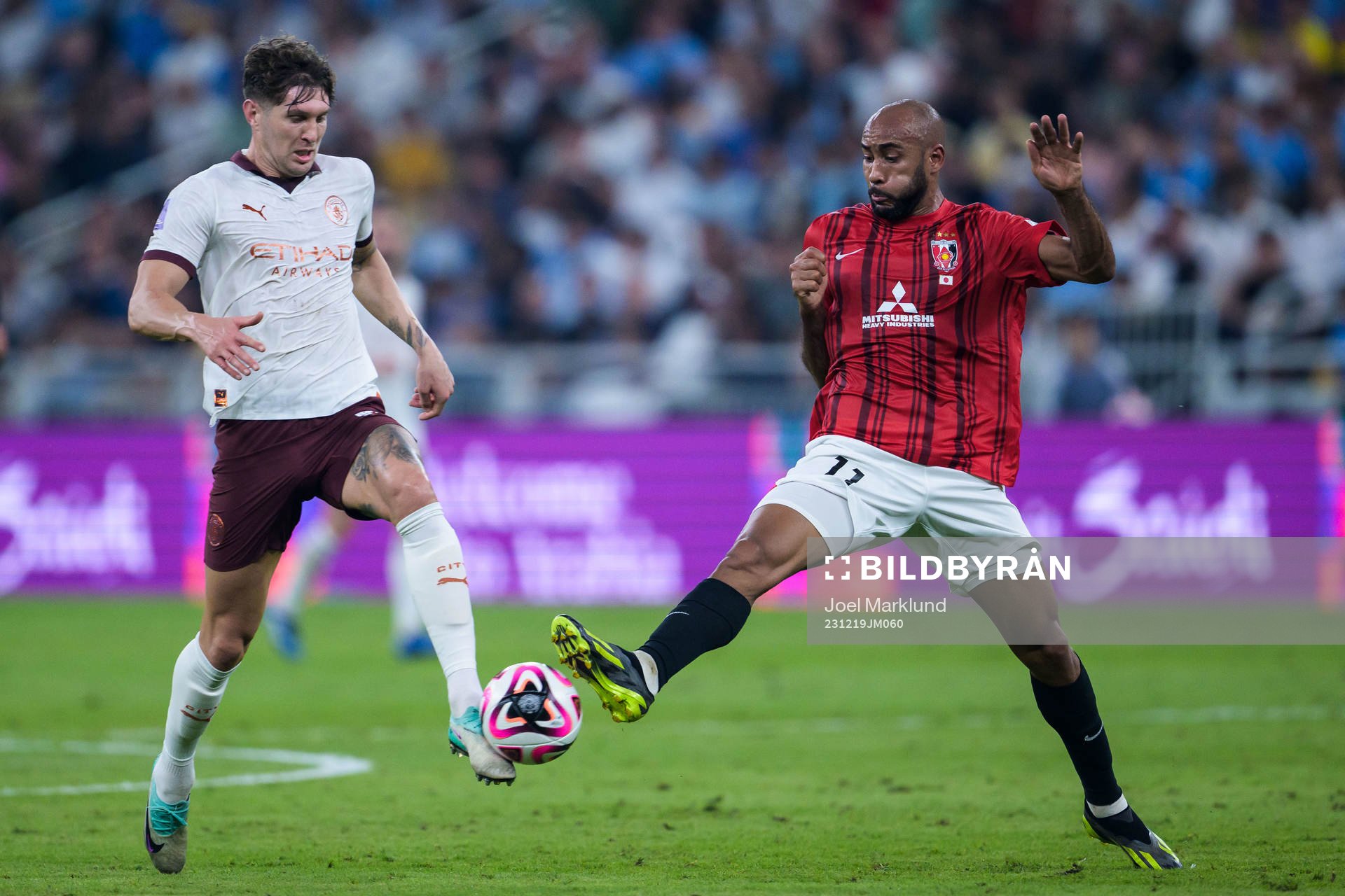 John Stones of Manchester City and Jose Kante of Urawa Reds