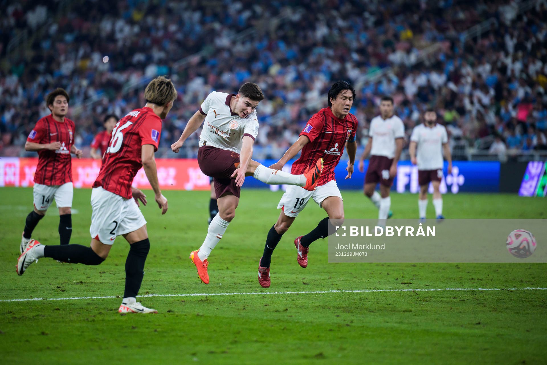 Julian Alvarez of Manchester City and Ken Iwao of Urawa Reds