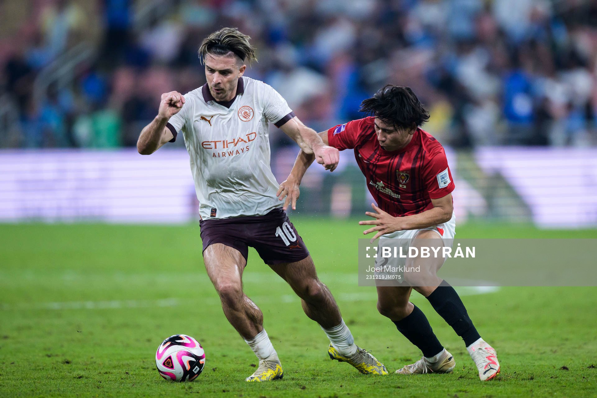 Jack Grealish of Manchester City and Kaito Yasui of Urawa