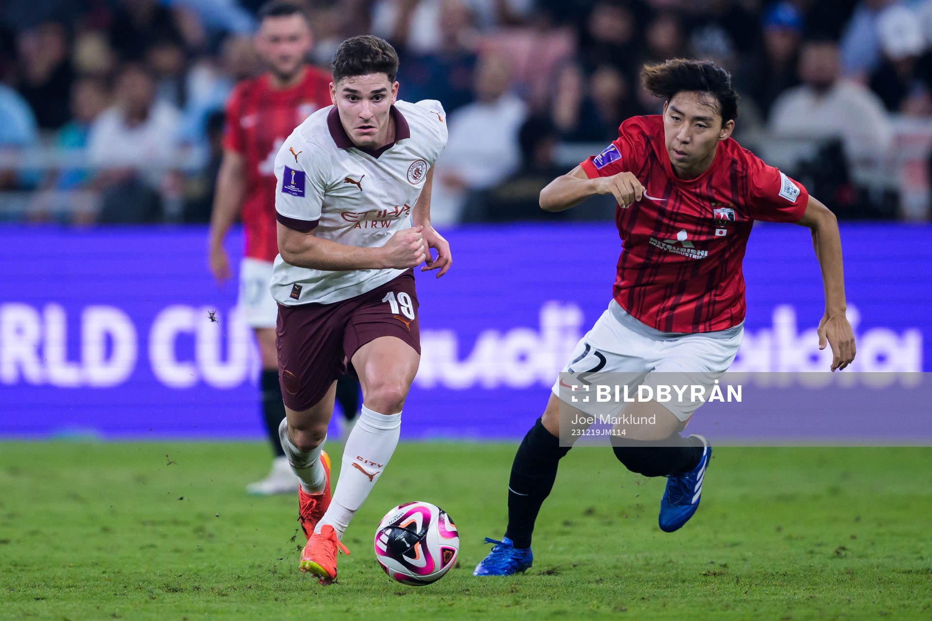 Julian Alvarez of Manchester City and Kai Shibato of Urawa