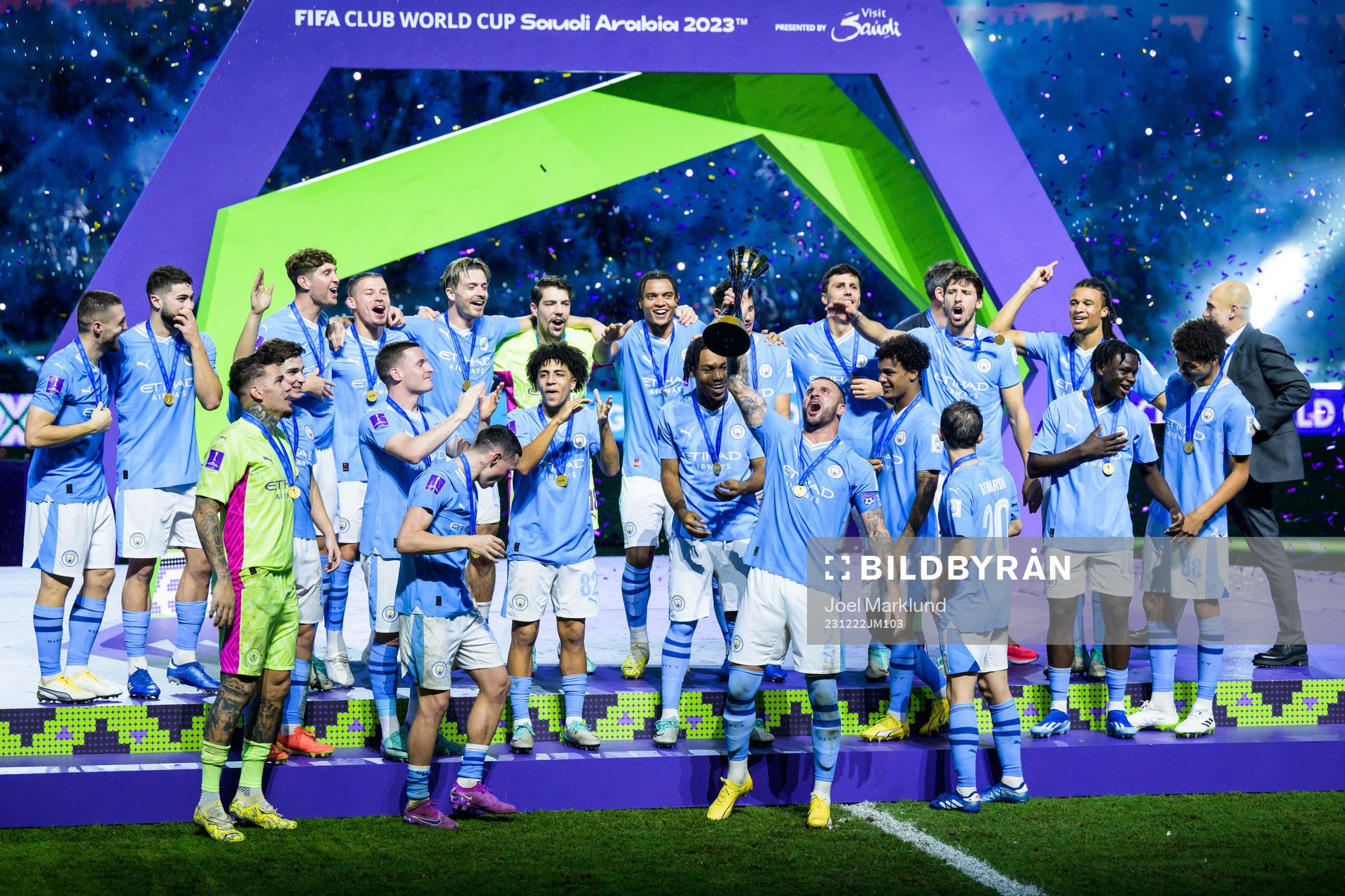 Players of Manchester City celebrate with the trophy