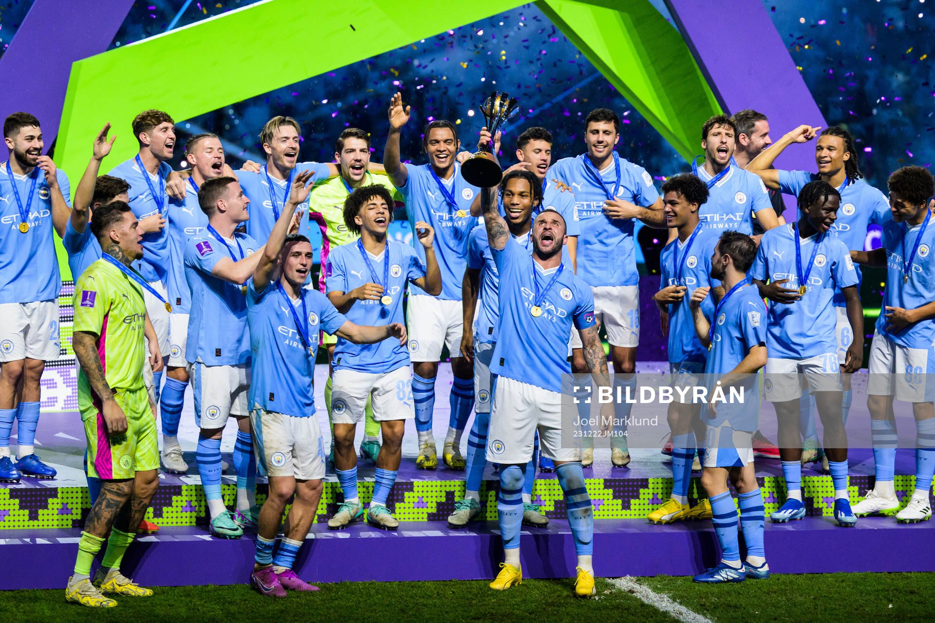 Players of Manchester City celebrate with the trophy