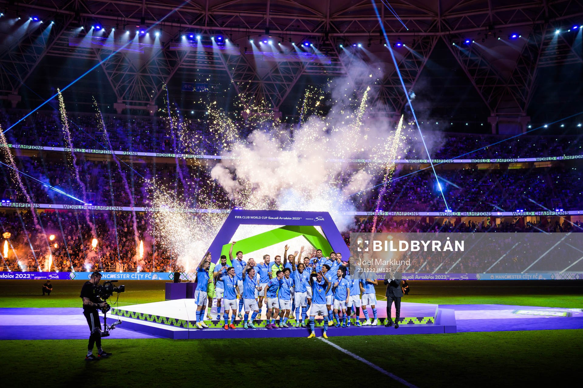Kyle Walker of Manchester City hoists the winner’s trophy