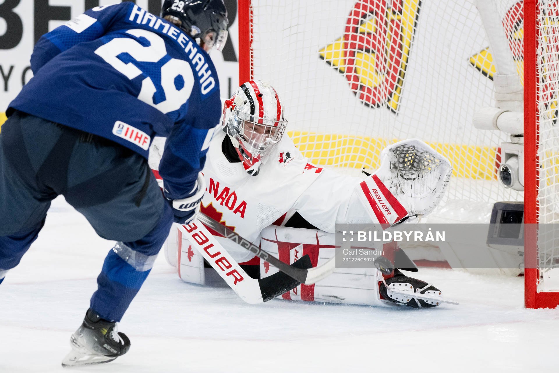 Goaltender Mathis Rousseau of Canada with a save