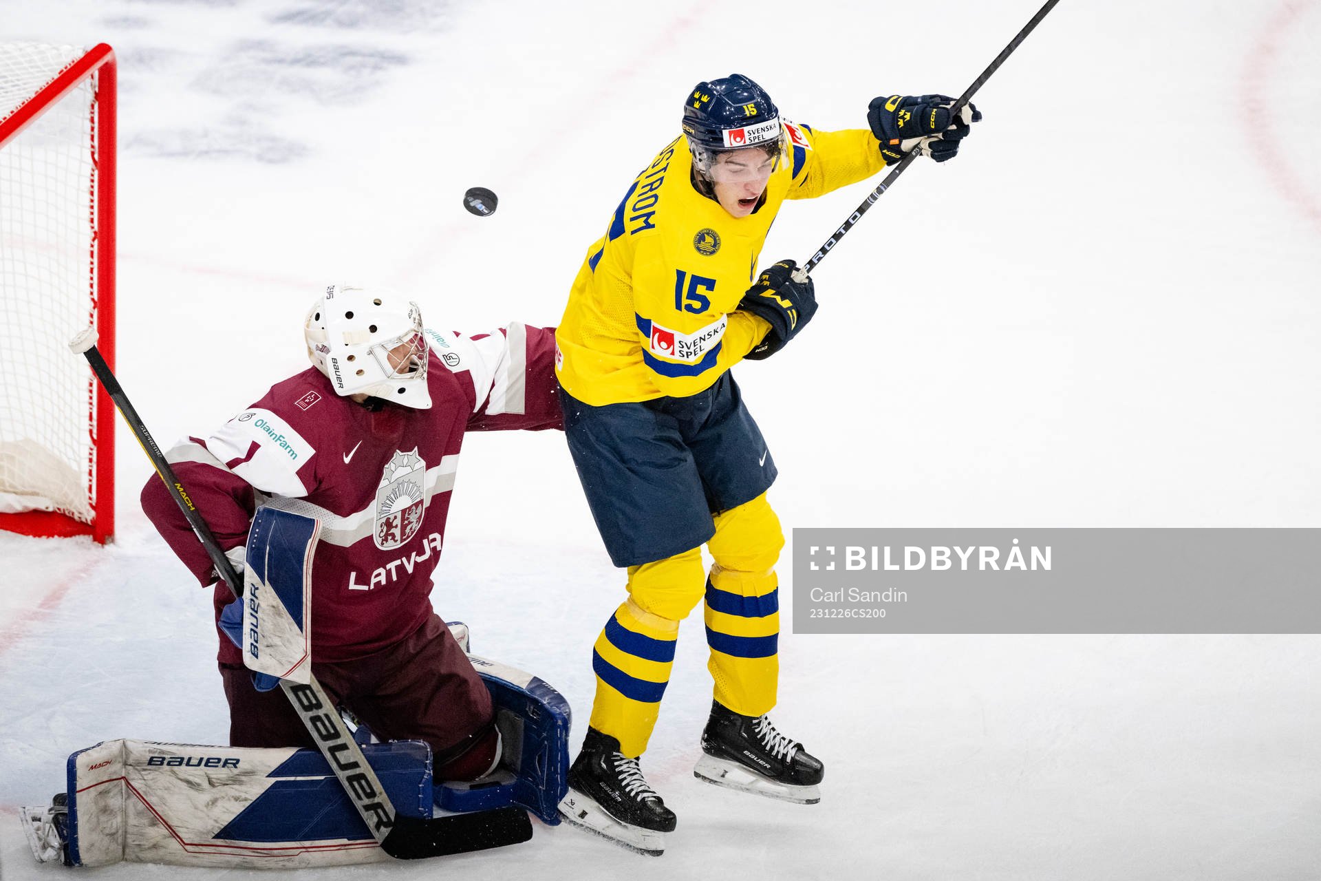 Goaltender Deivs Rolovs of Latvia and David Edstrom of