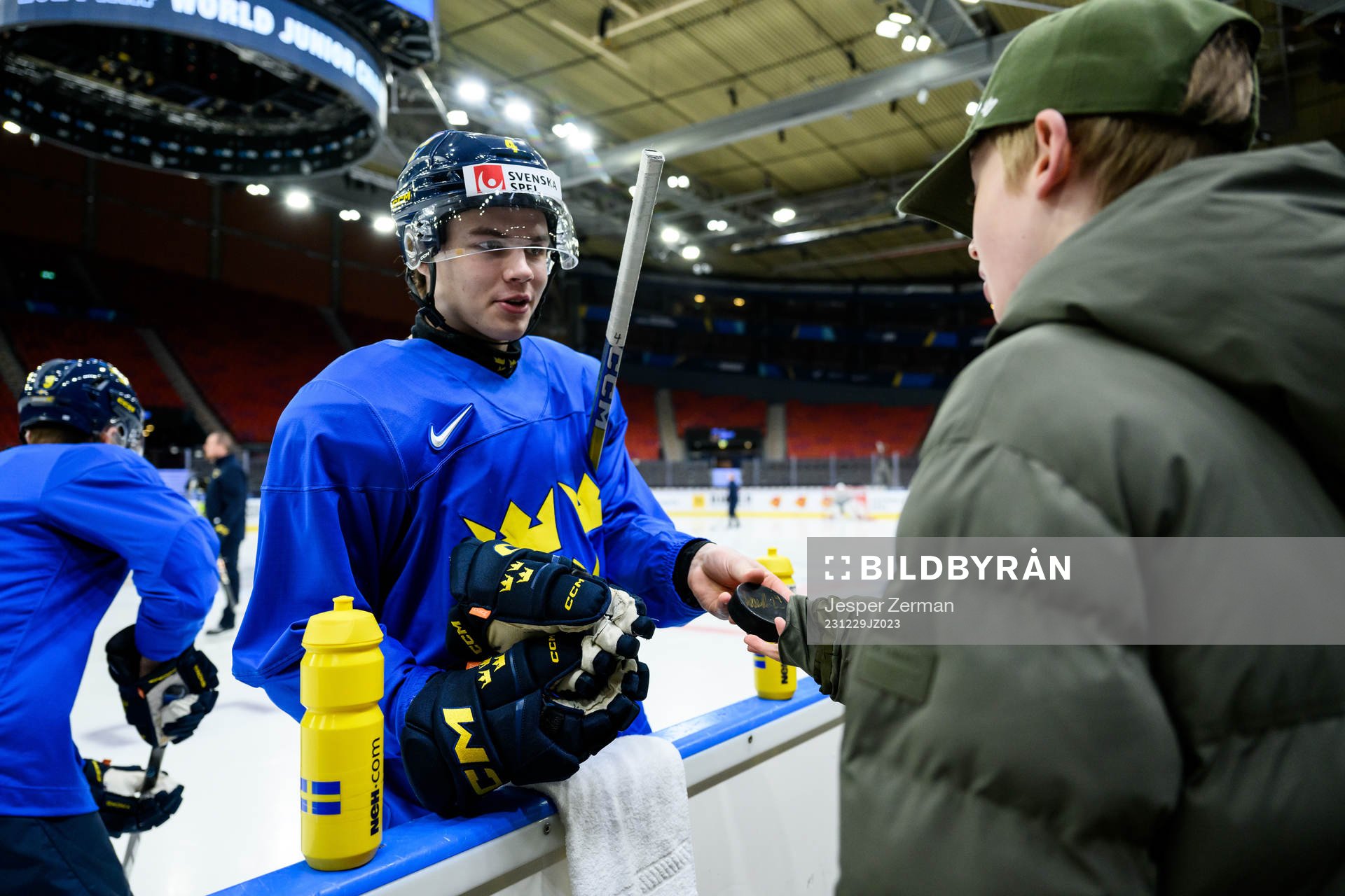 Axel Sandin-Pellikka of Sweden giveas a puck to a supporter