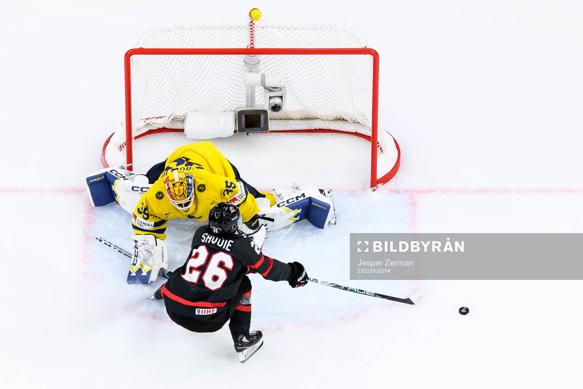 goaltender Hugo Hävelid of Sweden and Matthew Savoie of