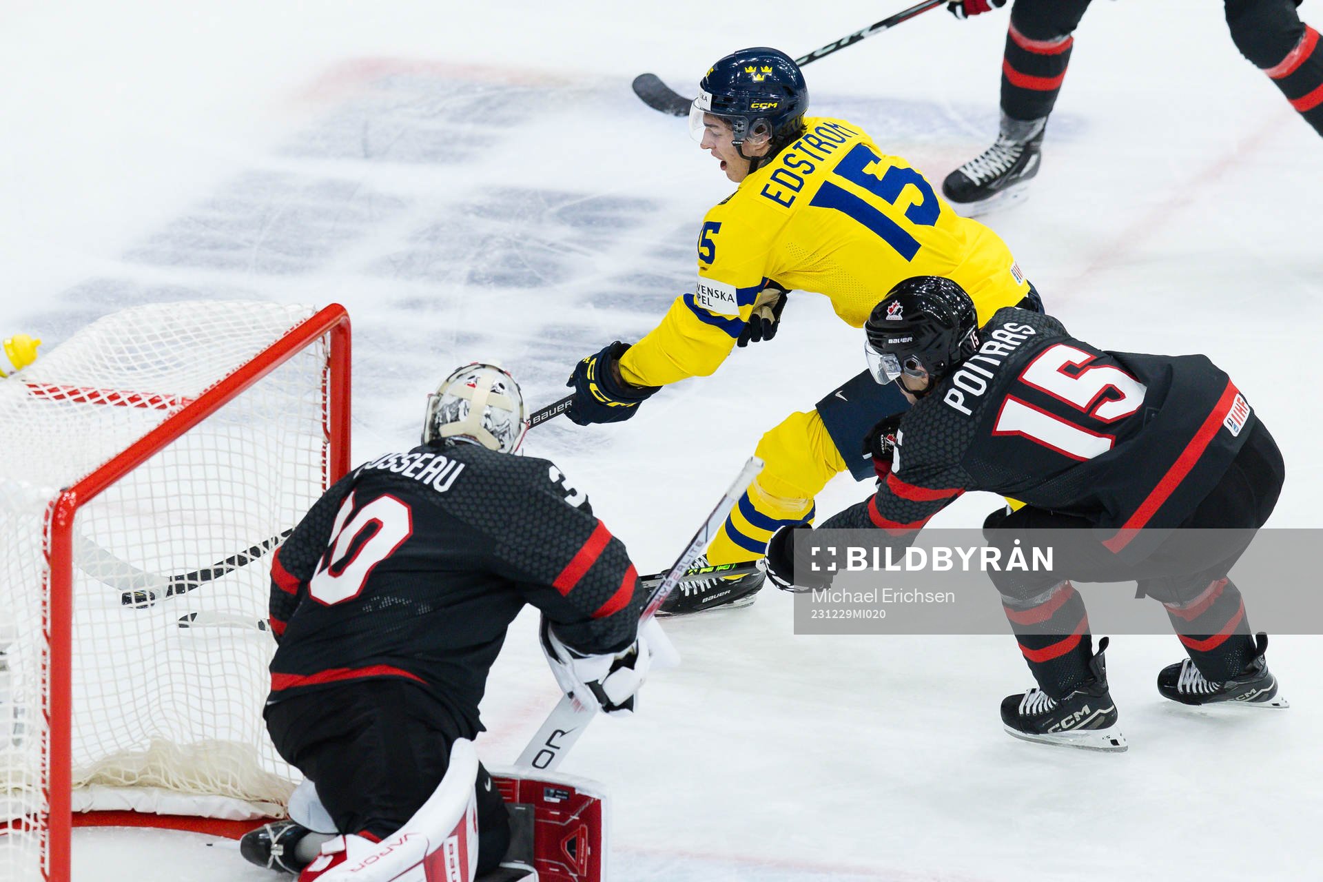 Goalkeeper Mathis Rousseau and Matthew Poitras of Canada