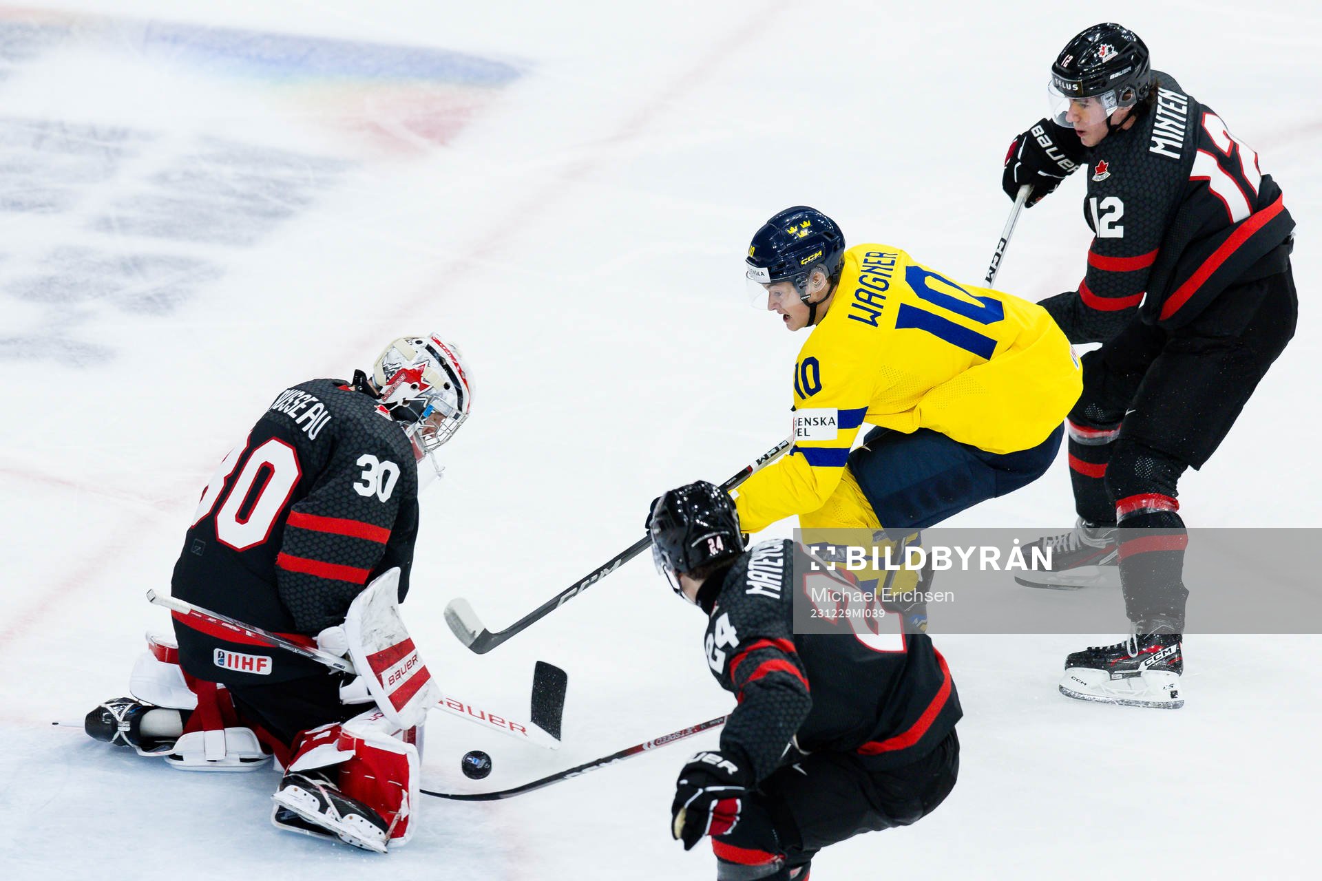 Goaltender Mathis Rousseau of Canada and Fabian Wagner of