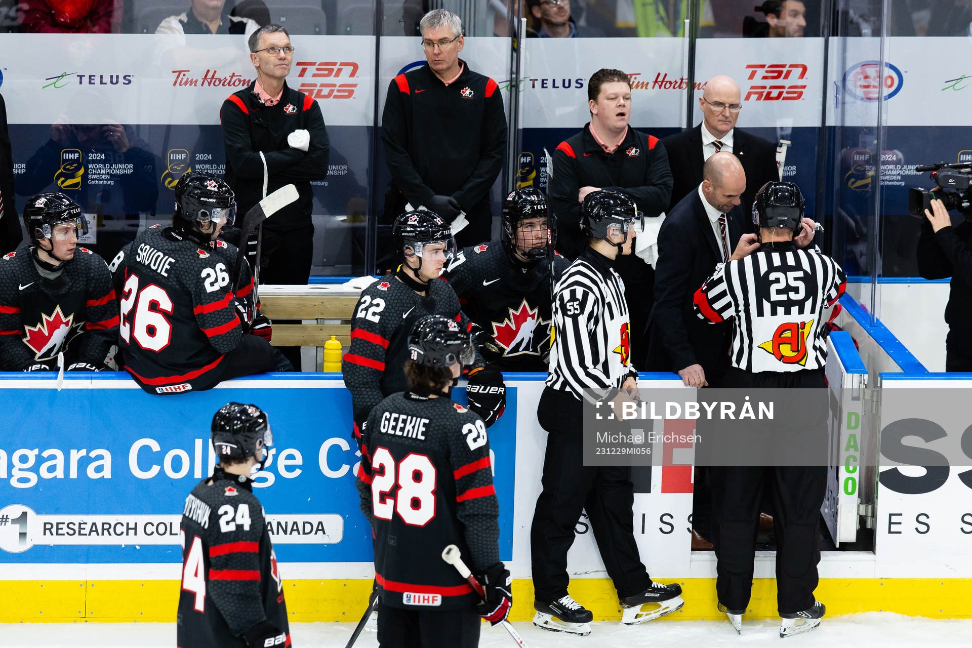 Referee Tobias Björk and head coach Alan Letang of Canada