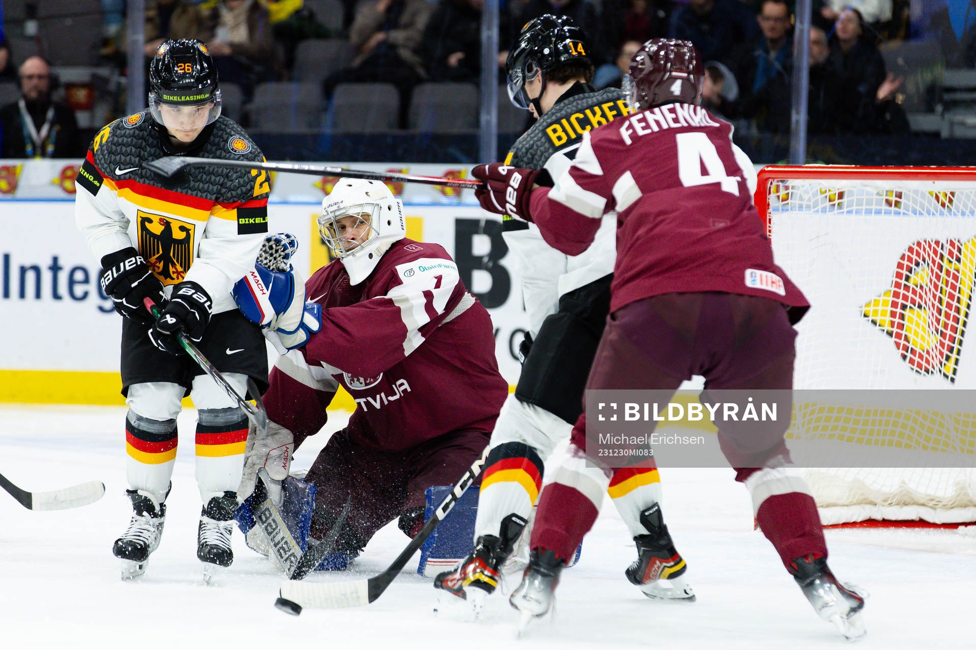 Goaltender Deivs Rolovs of Latvia and Moritz Elias and
