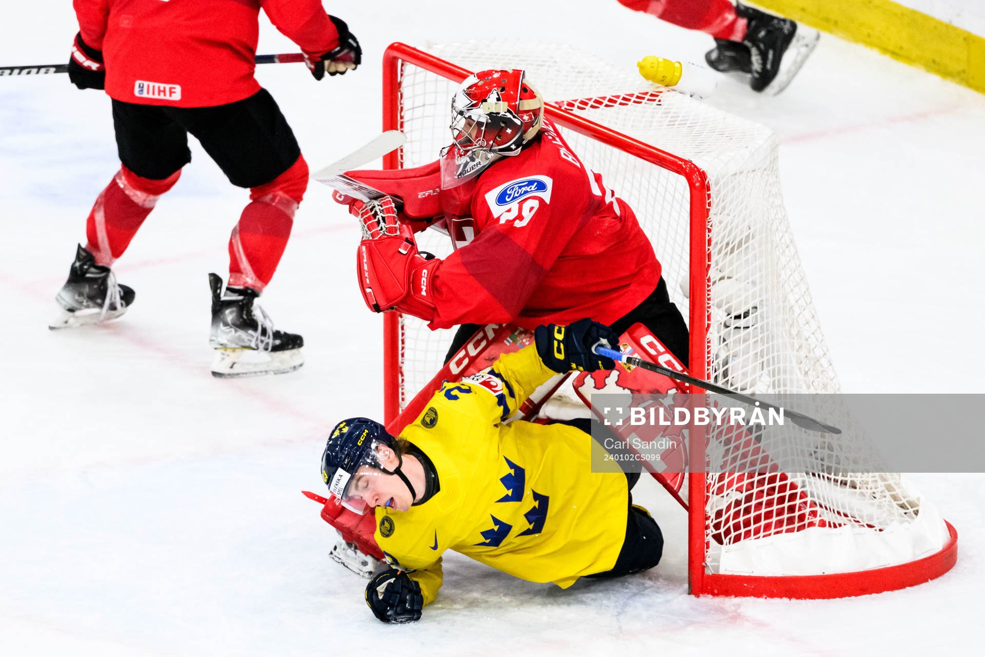 Jonathan Lekkerimäki of Sweden and goaltender Alessio