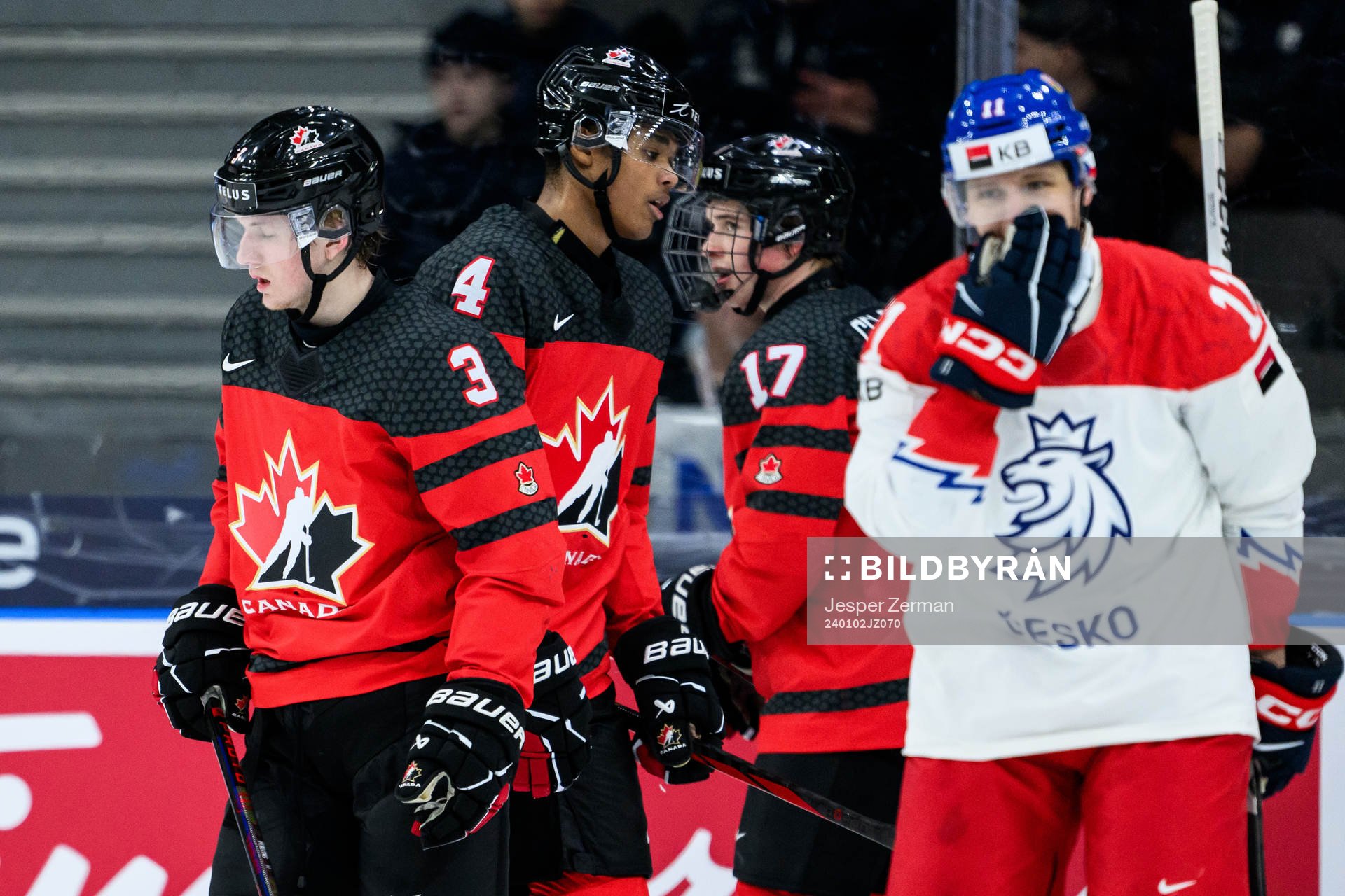 Jake Furlong, Noah Warren and Macklin Celebrini of Canada