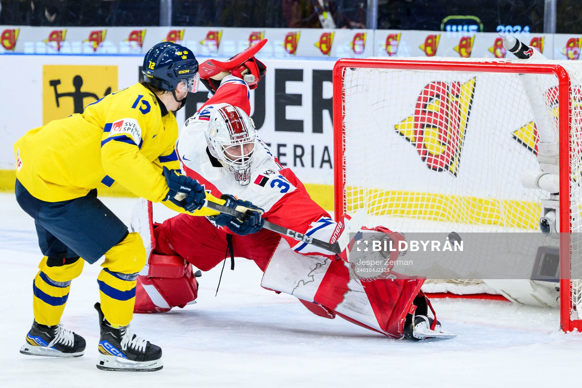 Noah Östlund of Sweden scores the 5-2 goal behind