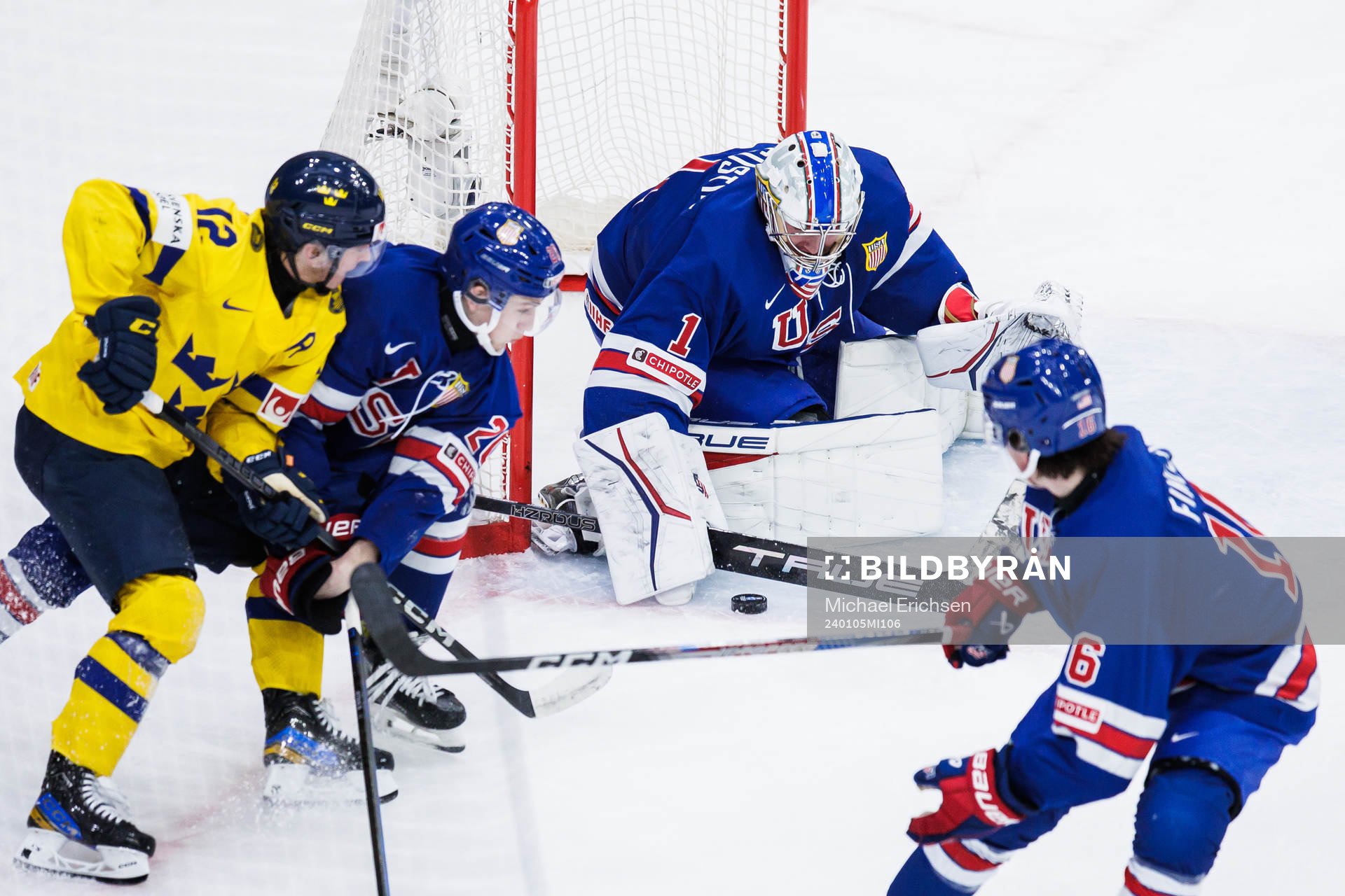 Noah Östlund of Sweden against Lane Hutson and goaltender