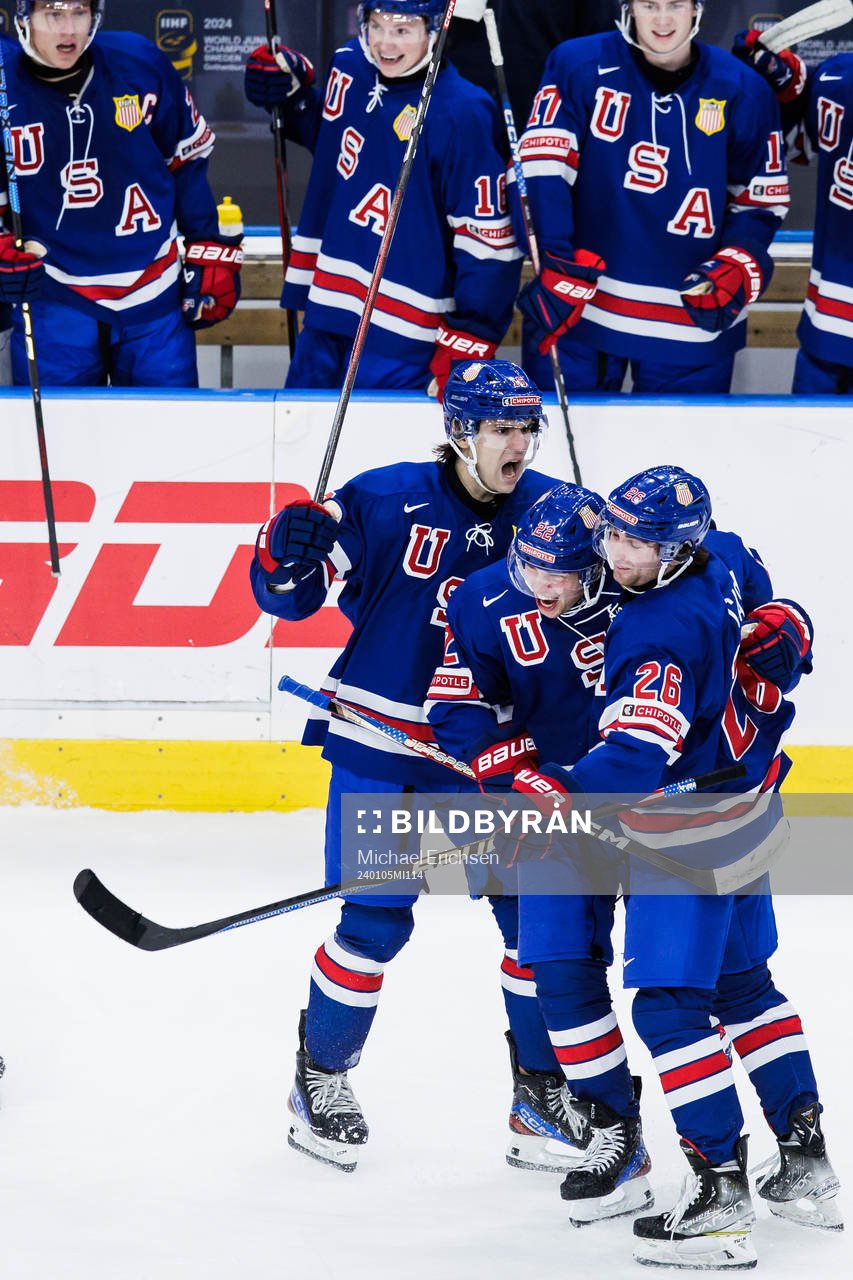 Cutter Gauthier and Seamus Casey celebrate with Isaac Howard