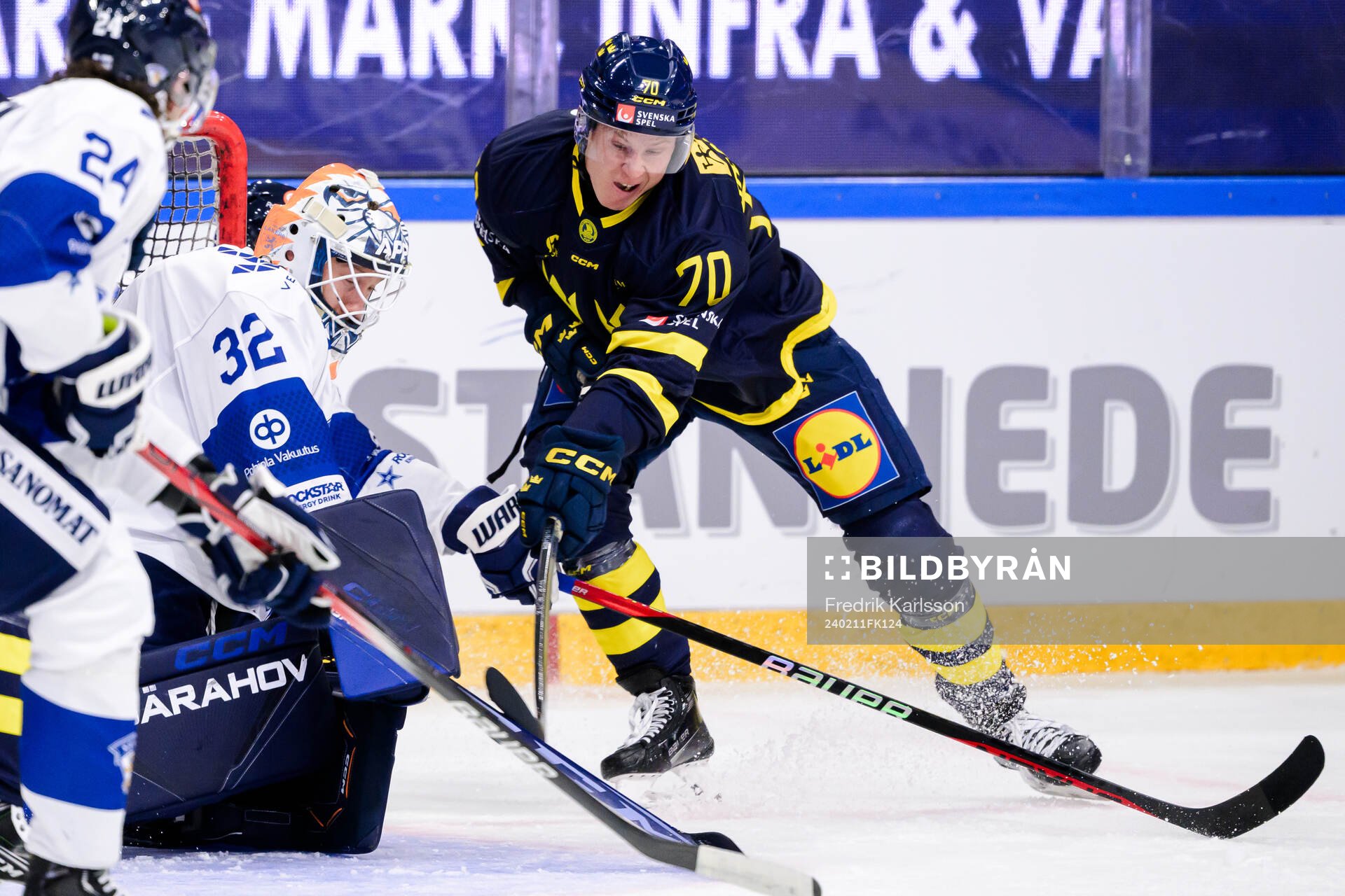 goaltender Emil Larmi of Finland and Dennis Rasmussen of