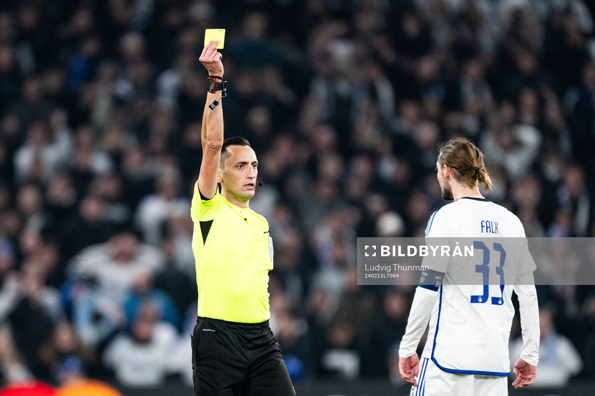 Rasmus Falk of FC Copenhagen receives a yellow card from