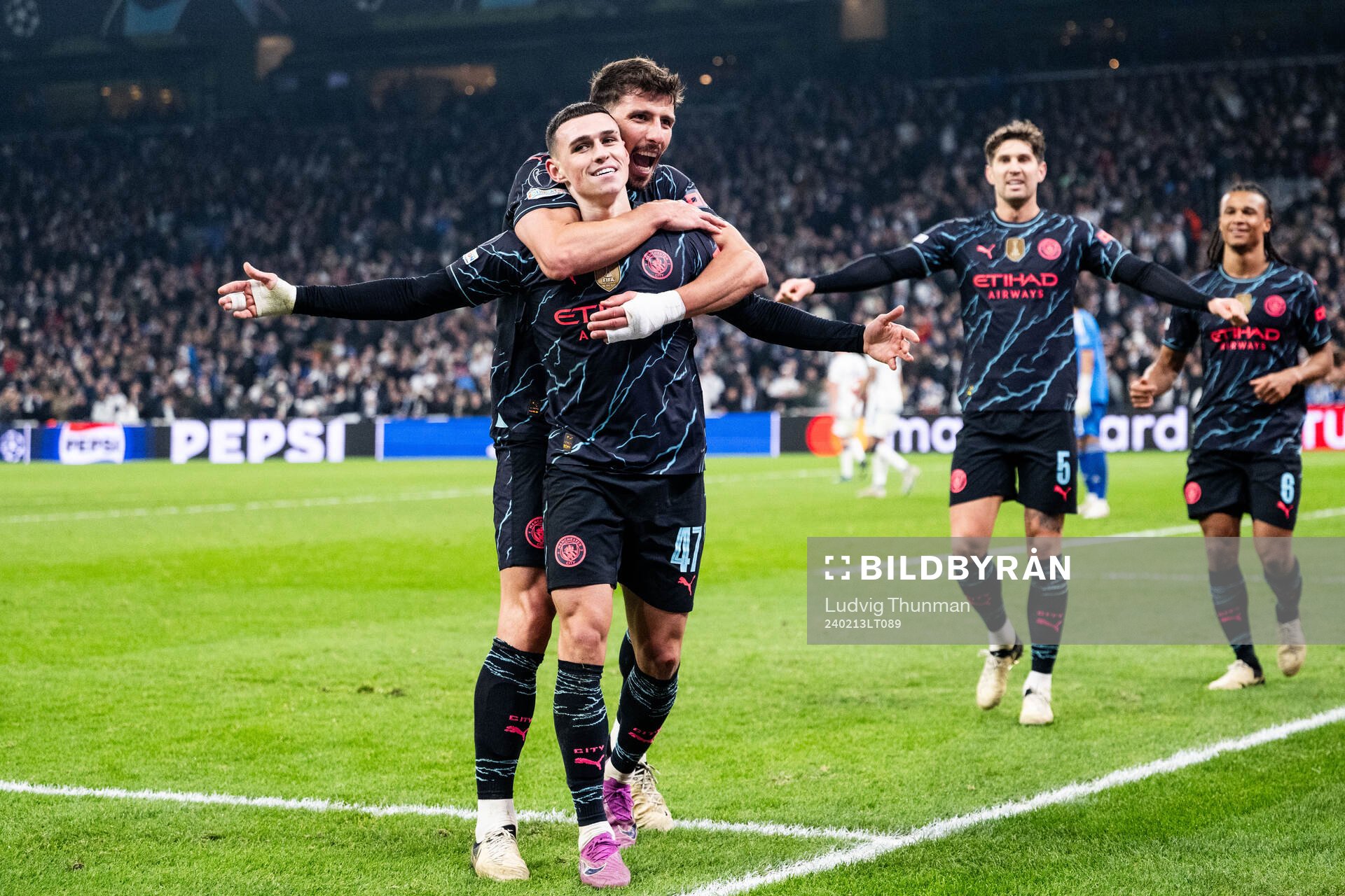 Phil Foden of Manchester City celebrates with Ruben Dias