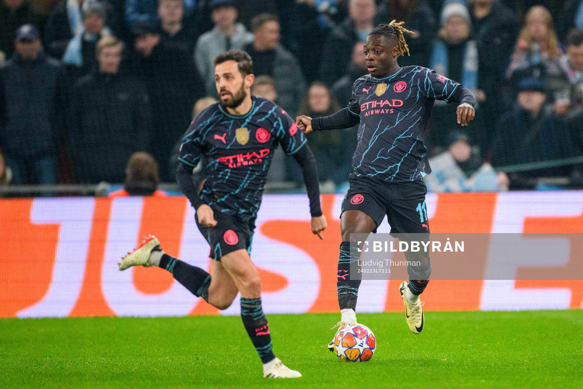 Jérémy Doku and Bernardo Silva of Manchester City