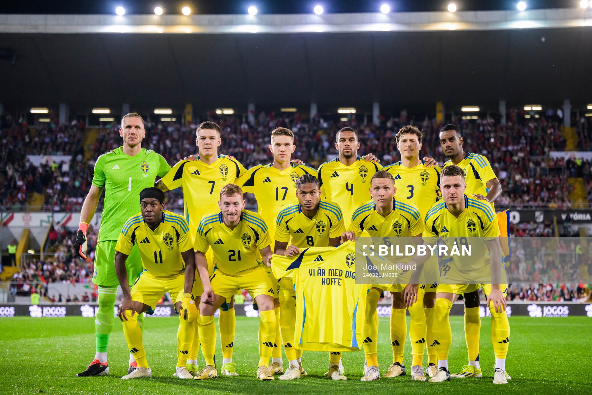 The starting eleven of Sweden pose for a photo as they hold a shirt with a message to Swedish player Kristoffer Olsson who has been hospitalized ahead of the international friendly football match between Portugal and Sweden on March 21, 2024 in Guimaraes. From the top left: Goalkeeper Robin Olsen, Emil Holm, Viktor Gyökeres, Isak Hien, Victor Nilsson Lindelöf and Alexander Isak. Bottom from left, Anthony Elanga, Dejan Kulusevski, Jens Cajuste, Ludwig Augustinsson and Mattias Svanberg.