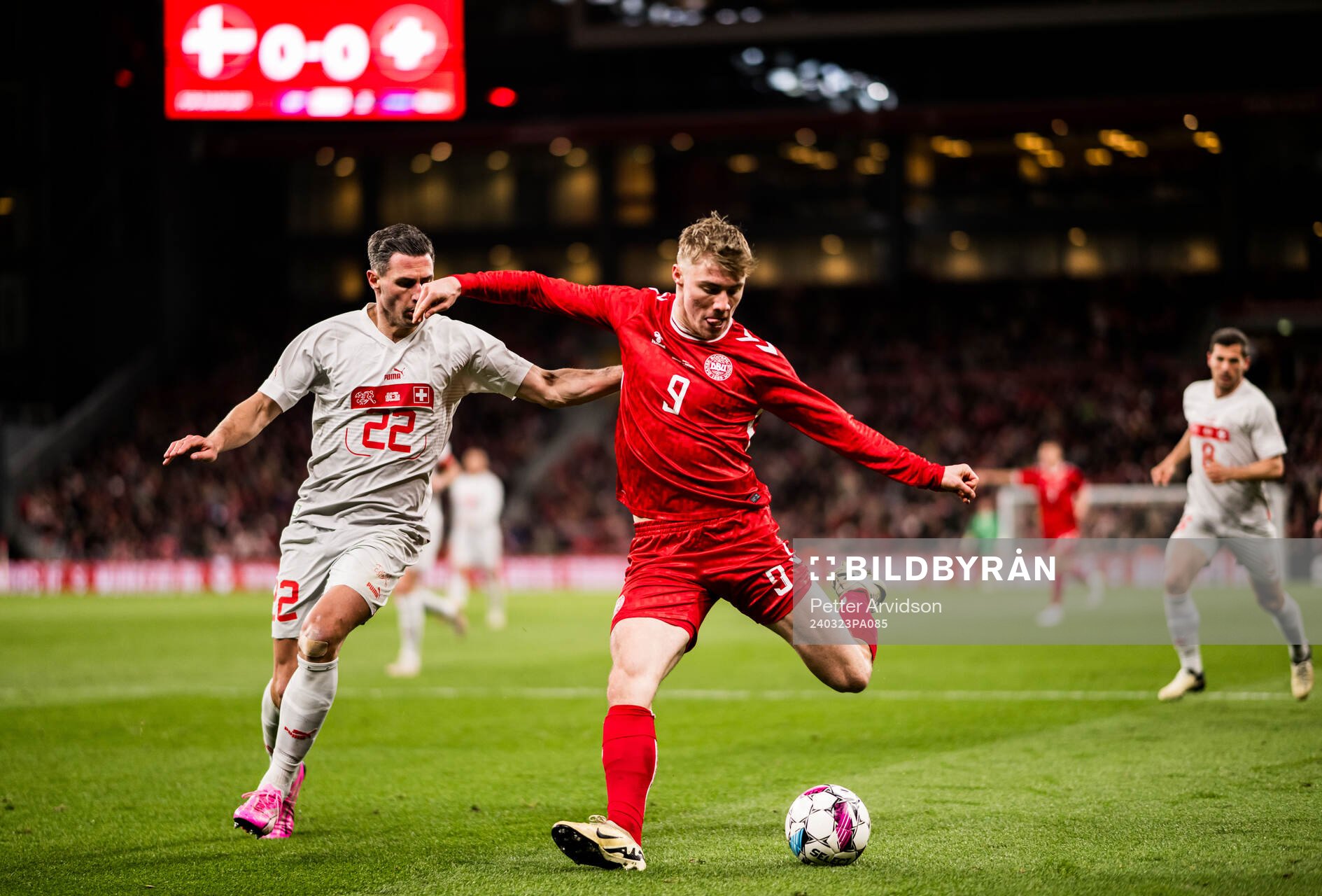 Fabian Schär of Switzerland and Rasmus Højlund of Denmark