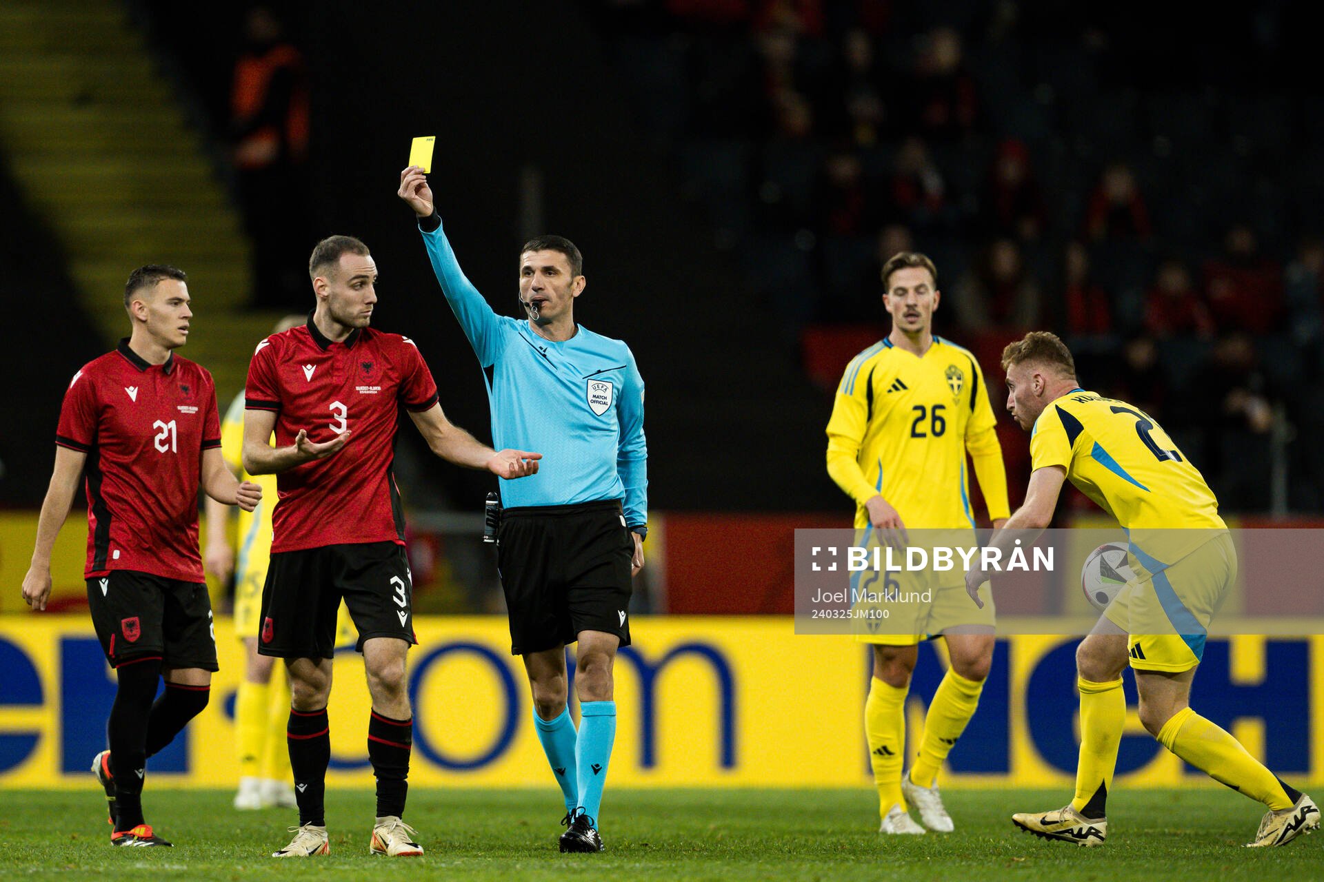 Mario Mitaj of Albania receives a yellow card from Referee