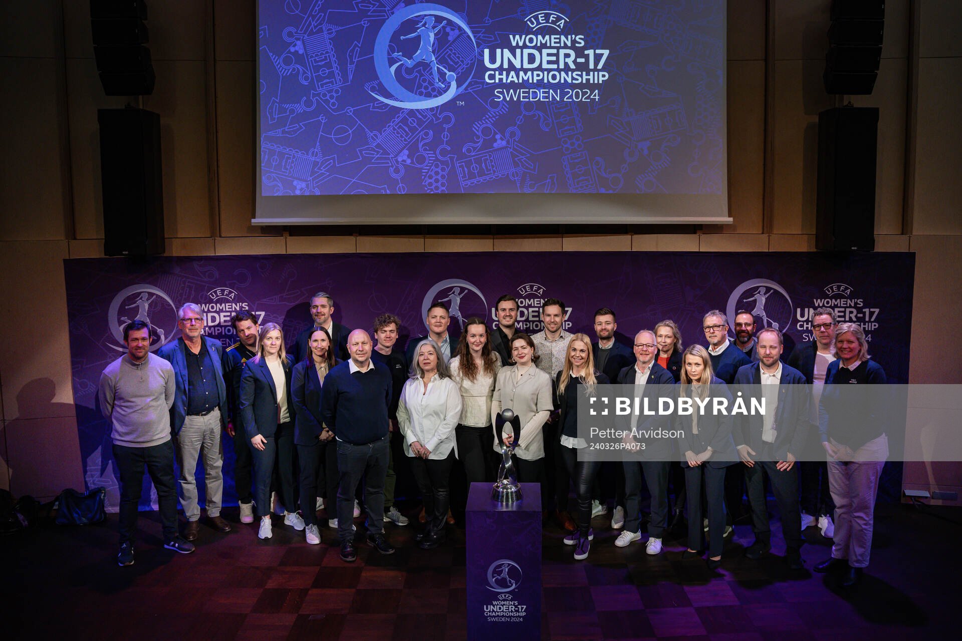 Representatives pose for a picture with the trophy