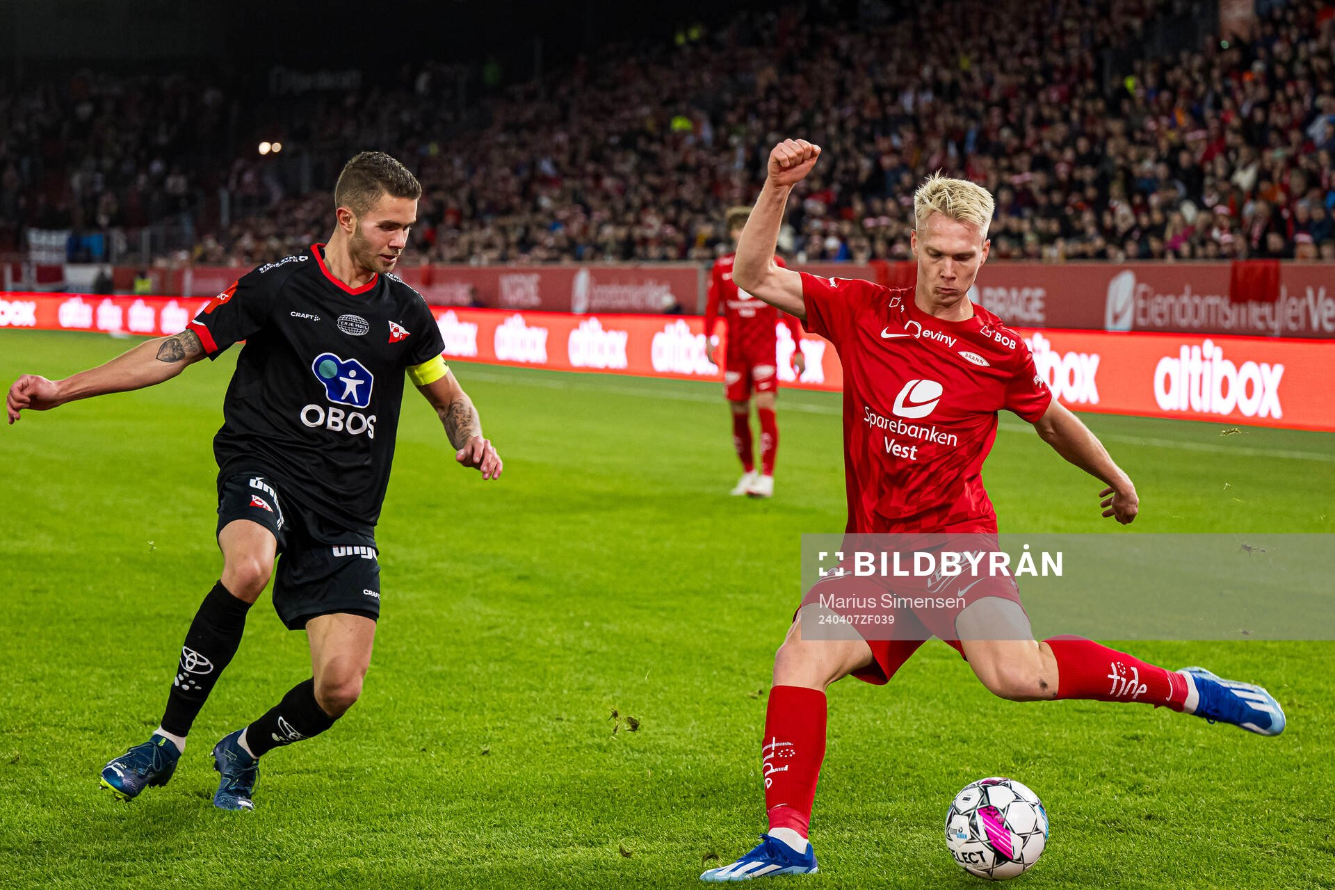 Julius Magnusson of Fredrikstad and Magnus Warming of Brann during the Eliteserien match between Brann and Fredrikstad on April 7, 2024 in Bergen.