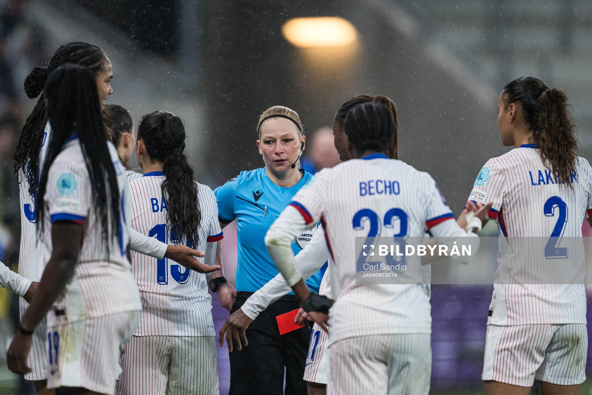 Referee Ewa Augustyn shows a red card