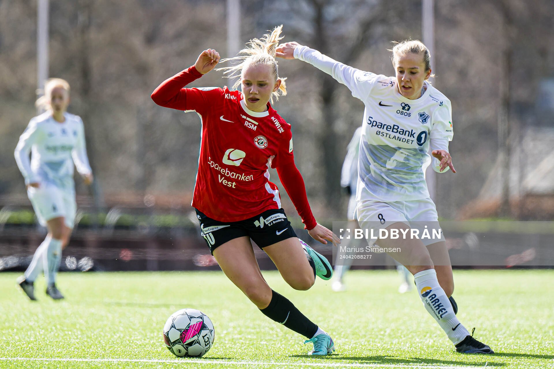 Linnéa Solvoll Laupstad of Arna-Bjørnar and Emilie Libakken Østerås of Stabæk during the Toppserien football match between Arna-Bjørnar and Stabæk on April 20, 2024 in Bergen.