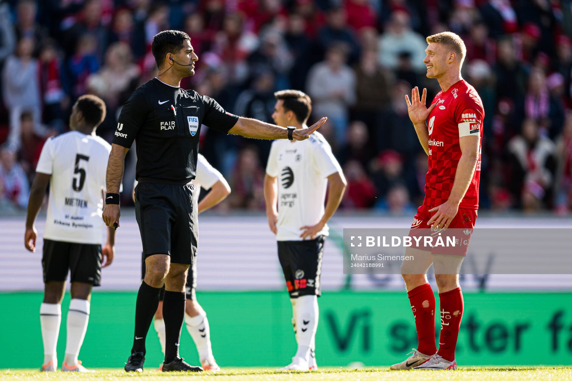 Mohammad Usman Aslam, referee, and Sivert Heltne Nilsen of