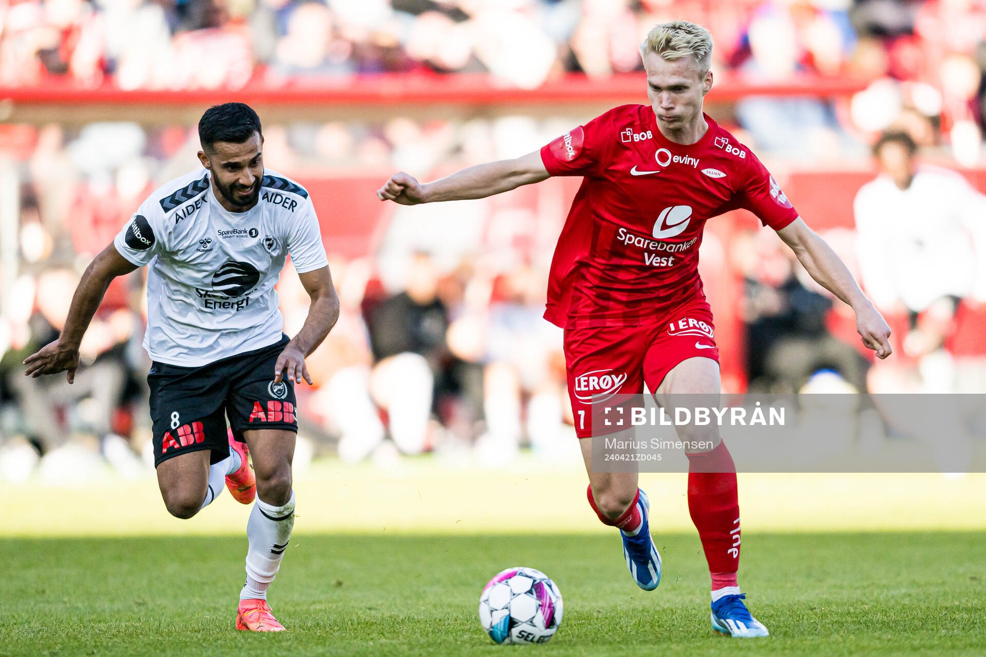 Etzaz Hussain of Odd and Magnus Warming of Brann during the Eliteserien match between Brann and Odd on April 21, 2024 in Bergen. 
