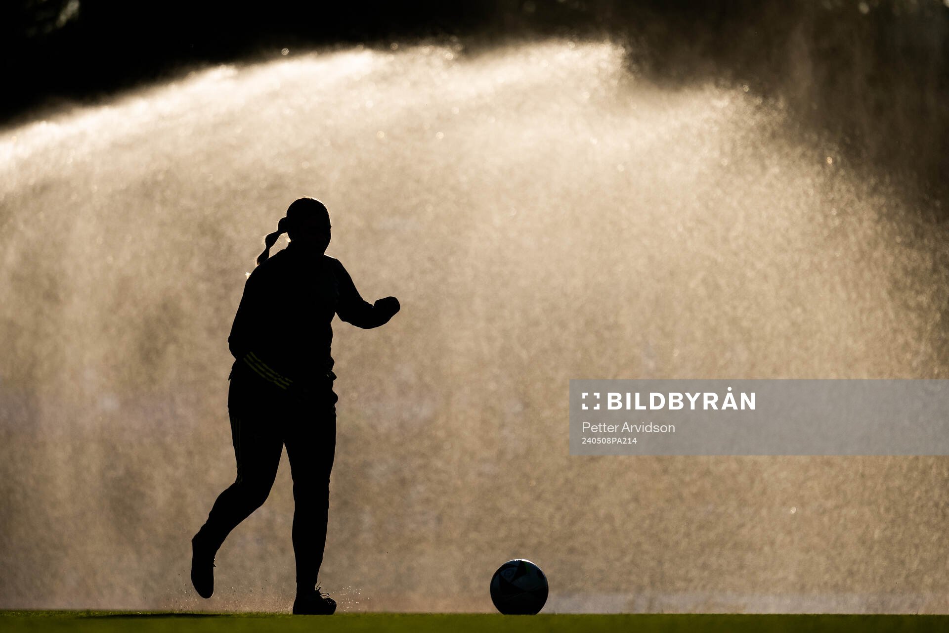 A silhouette of a player warming up