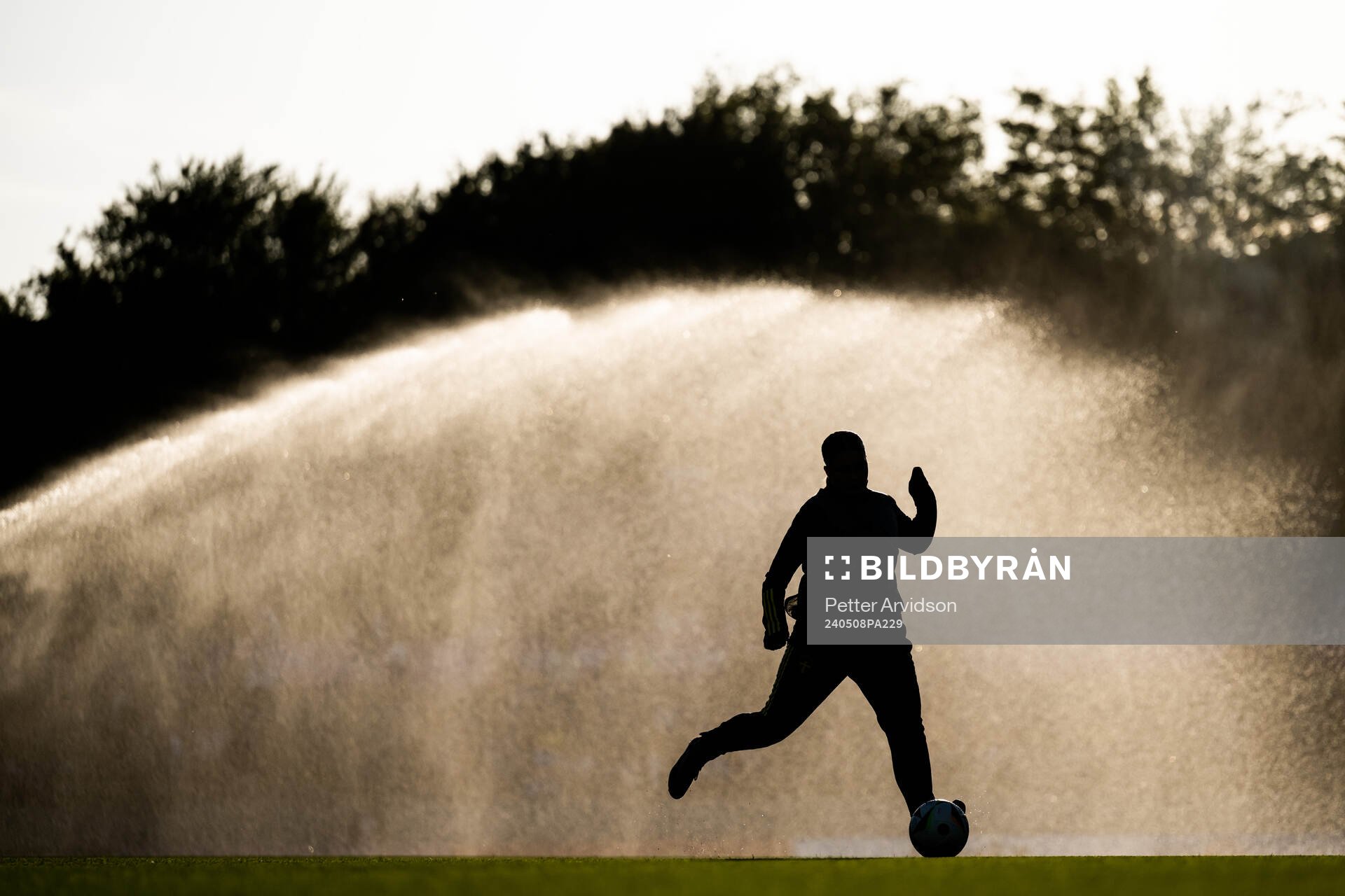 A silhouette of a player warming up