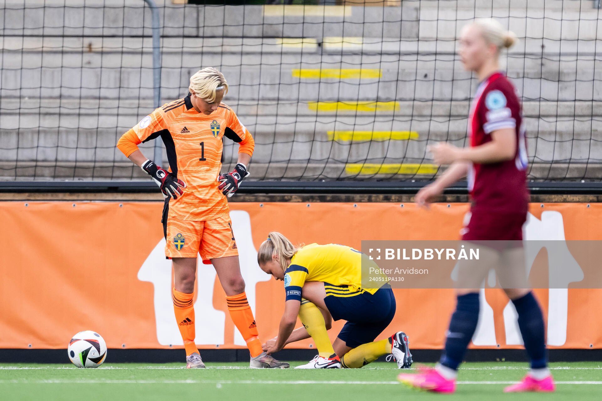 Alice Broman helps goalkeeper Saga Andersson of Sweden with