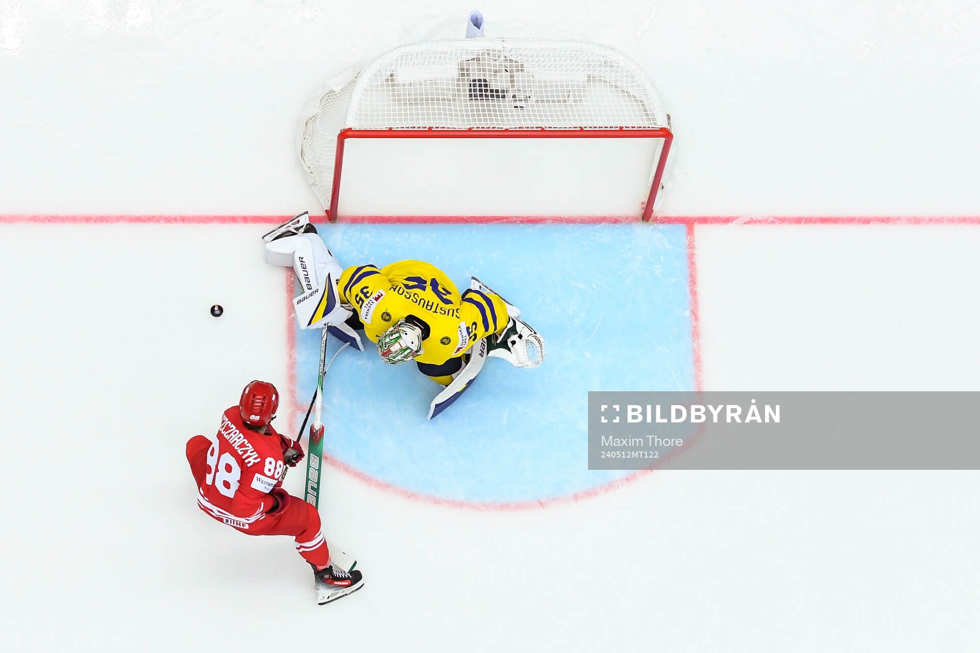 Alan Lyszczarczyk of Poland and goaltender Filip Gustavsson