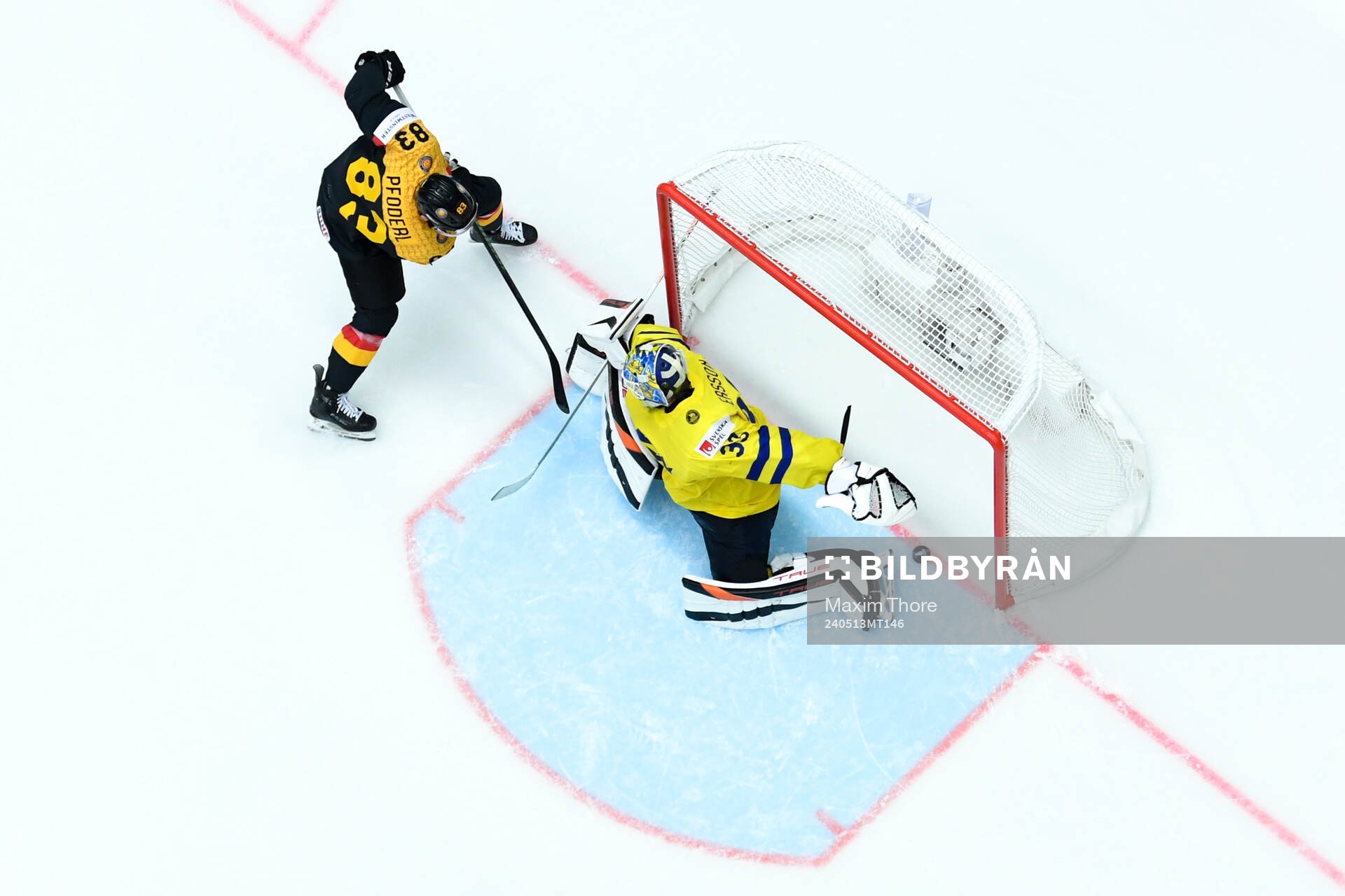 Leonhard Pfoderl of Germany and goaltender Samuel Ersson of
