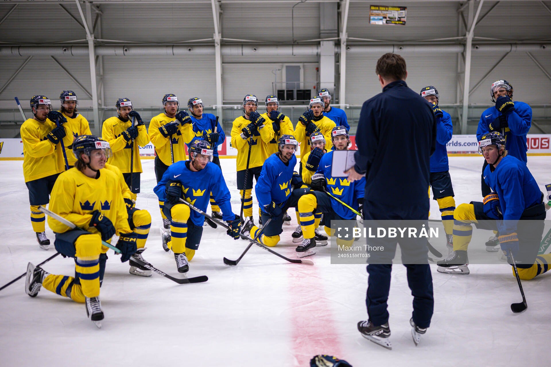 Players of Sweden gather around assistant coach Stefan
